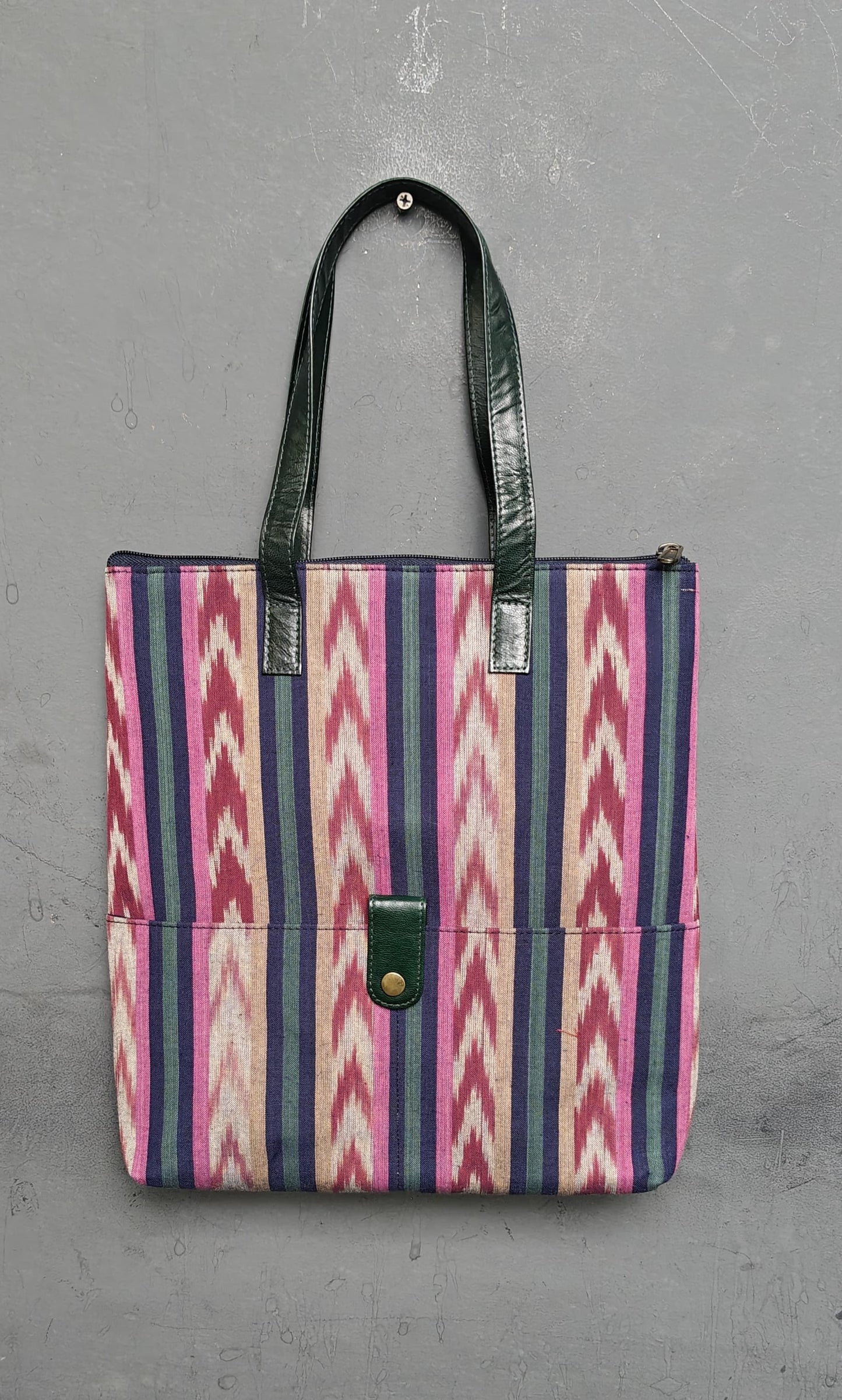Hand crafted fabric tote bag with leatherflap closure front pocket and leather handles