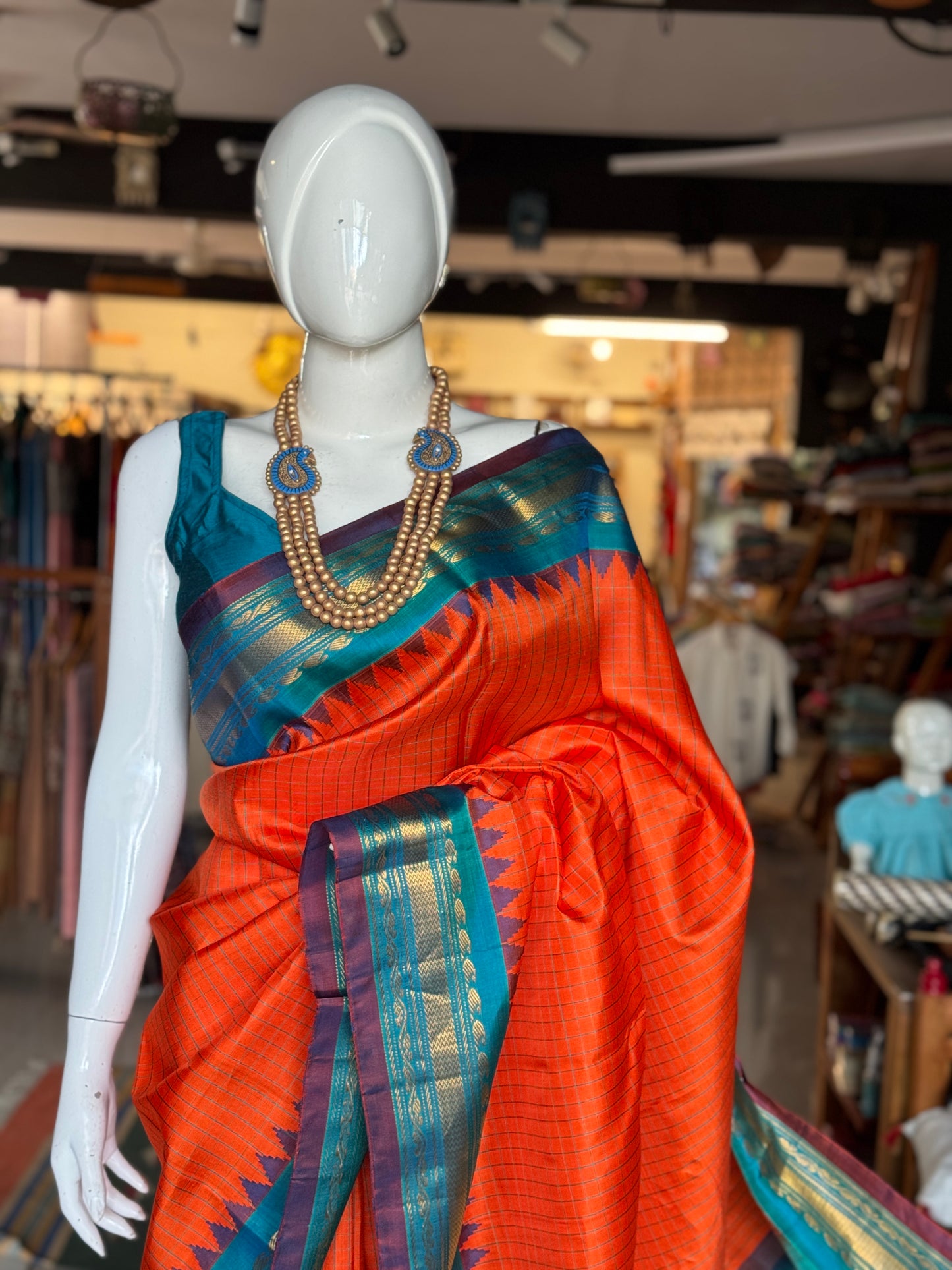 Gold spot orange and blue checks pure silk handwoven Gadwal saree with kuttu temple border