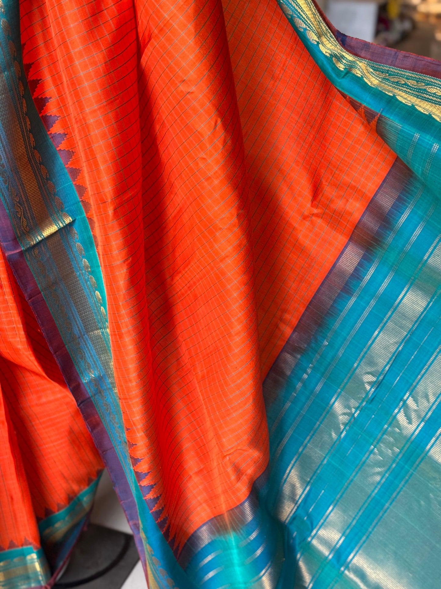Gold spot orange and blue checks pure silk handwoven Gadwal saree with kuttu temple border