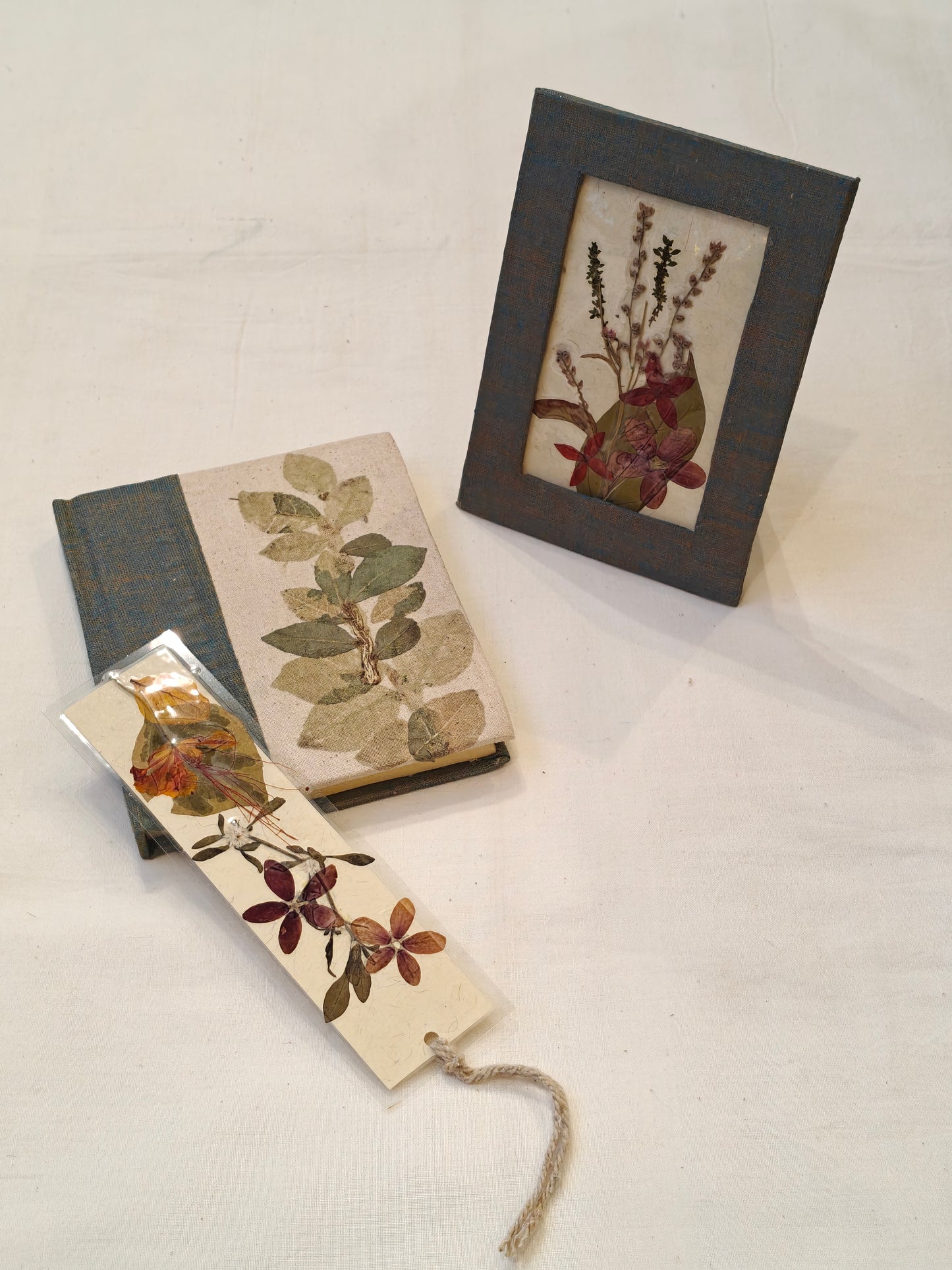 Handmade paper notebook with eco leaf printed fabric cover, hand crafted bookmark with dried flowers and a table frame pouch set