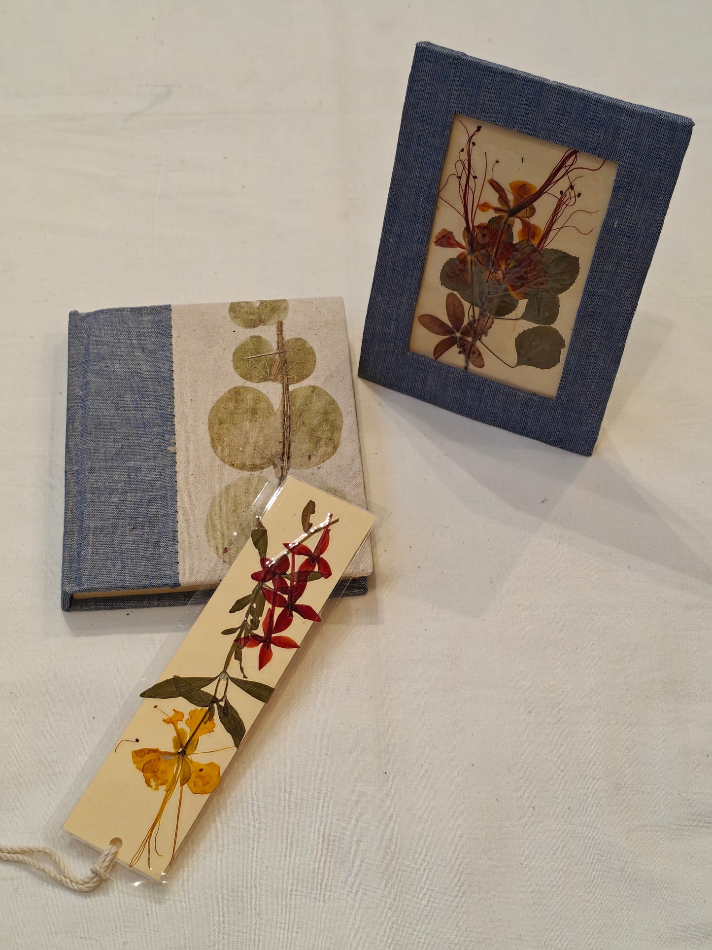 Handmade paper notebook with eco leaf printed fabric cover, hand crafted bookmark with dried flowers and a table frame pouch set