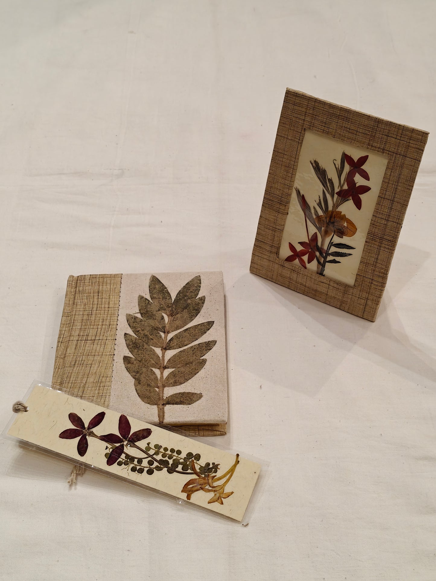 Handmade paper notebook with eco leaf printed fabric cover, hand crafted bookmark with dried flowers and a table frame pouch set