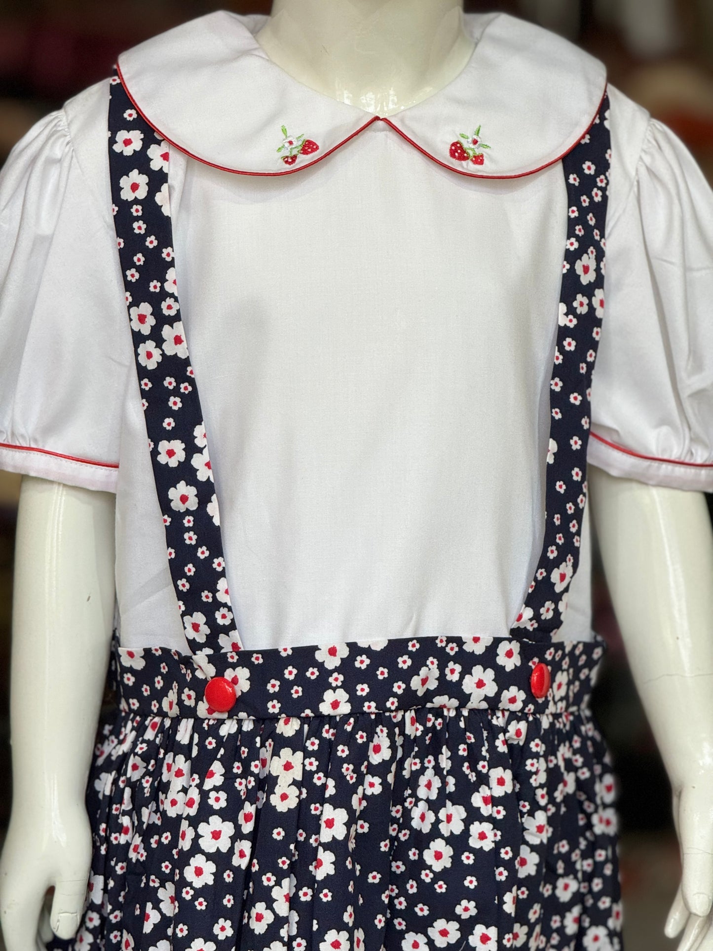Navy blue floral suspender look cotton embroidered frock with attached white collared top for girls