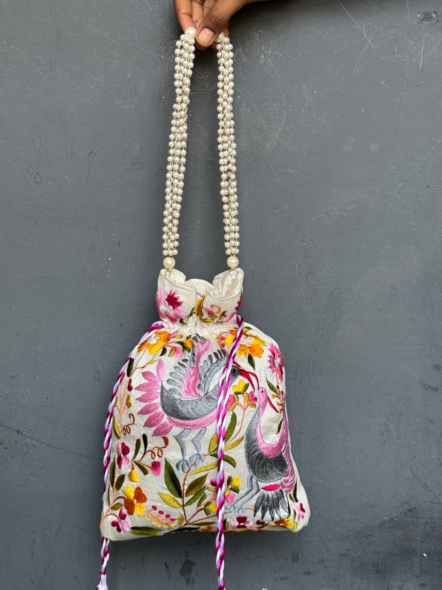 Parsi work party wear potlis with machine embroidery on art silk and pearl chain handle