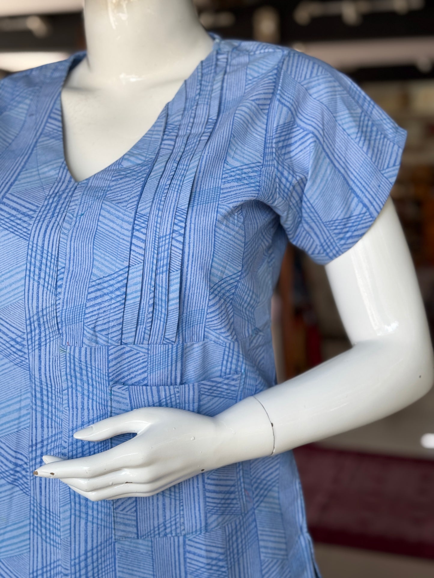 Blue geometric hand block printed cotton top with asymmetric pintucks and one side pocket