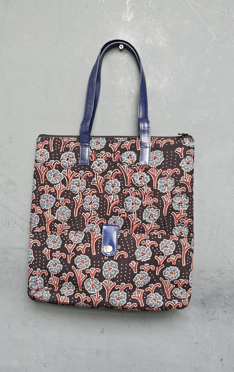 Hand crafted fabric tote bag with leatherflap closure front pocket and leather handles