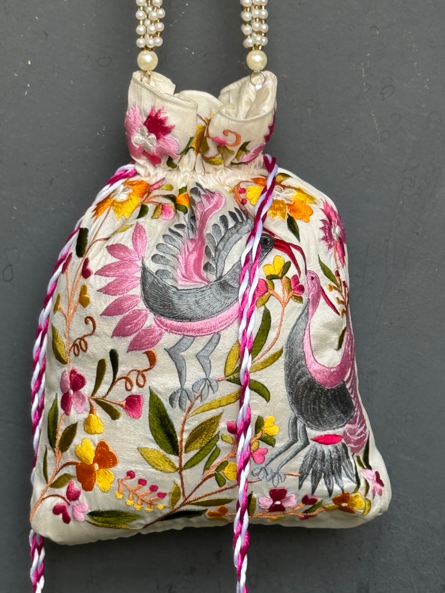 Parsi work party wear potlis with machine embroidery on art silk and pearl chain handle