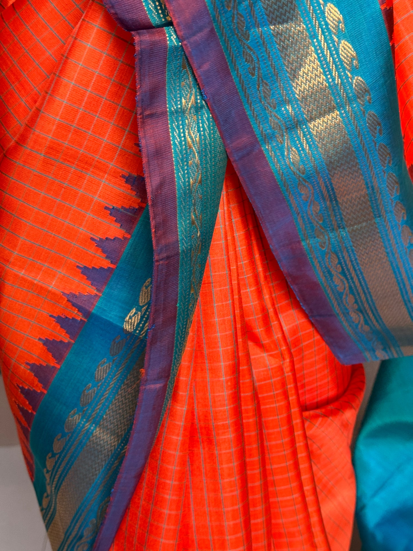 Gold spot orange and blue checks pure silk handwoven Gadwal saree with kuttu temple border