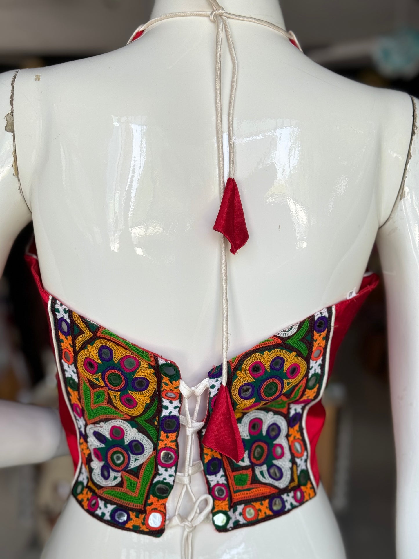 Bright red mashru super stylish halter neck blouse with Kutchi hand embroidery for back and waist
