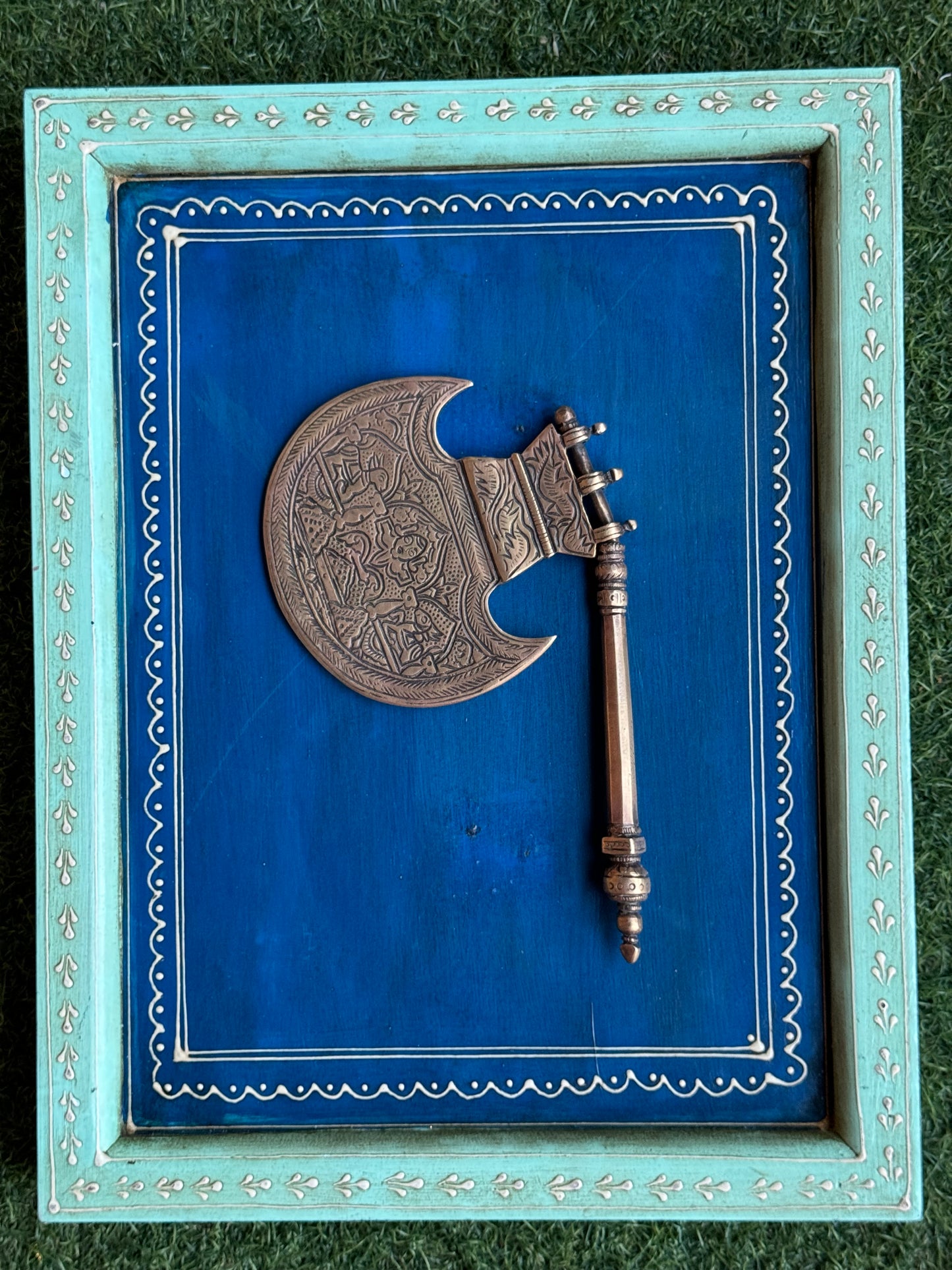 Vintage brass decorative fan with different engraved designs on both sides