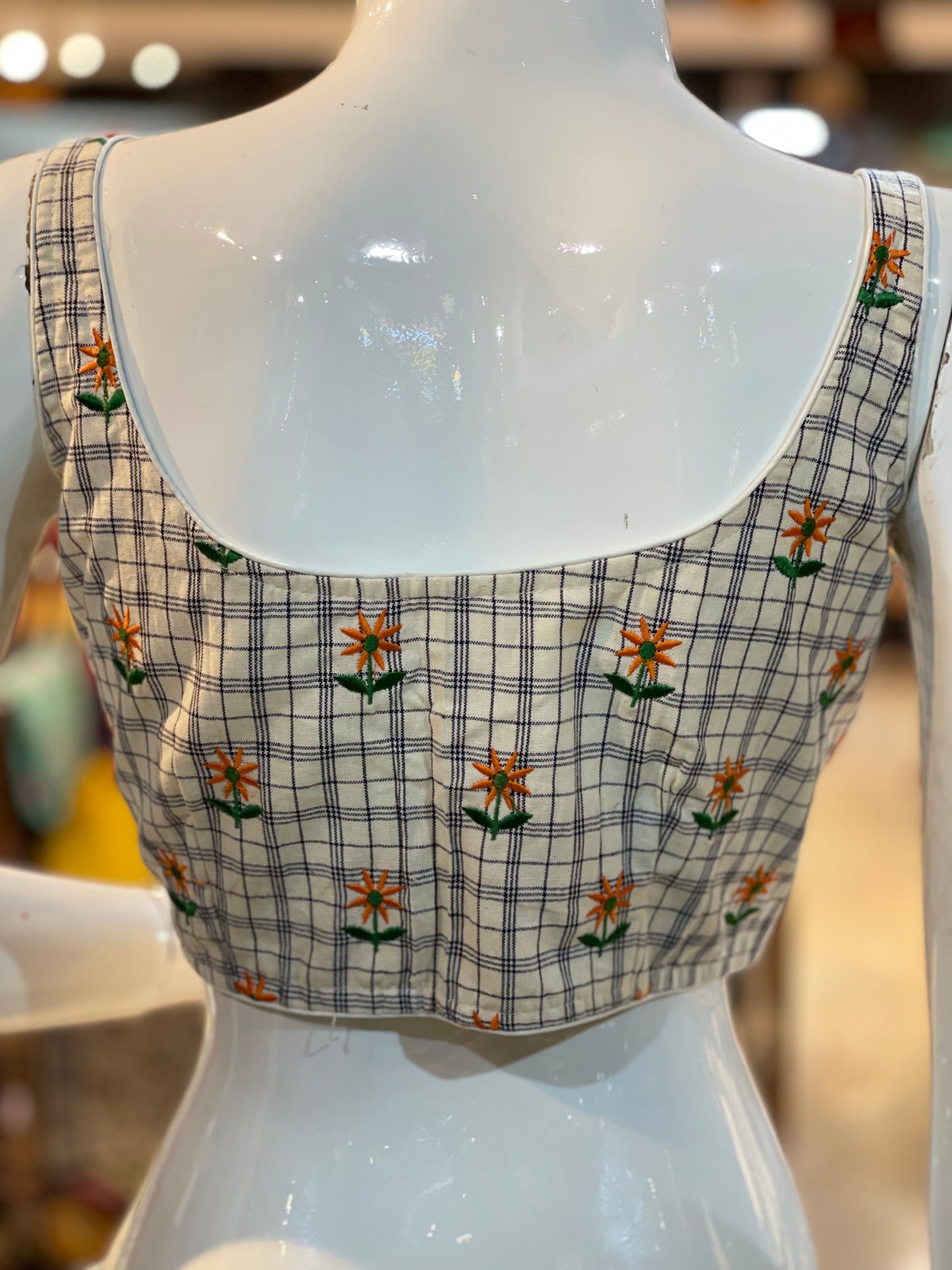 Off white checks sleeveless cotton blouse with floral embroidery