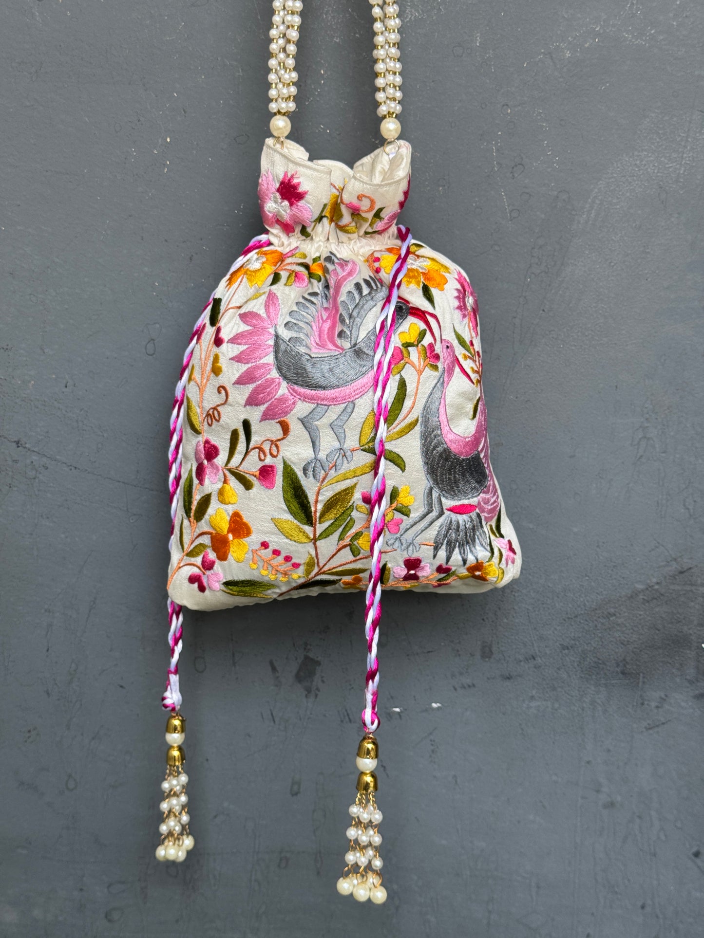 Parsi work party wear potlis with machine embroidery on art silk and pearl chain handle