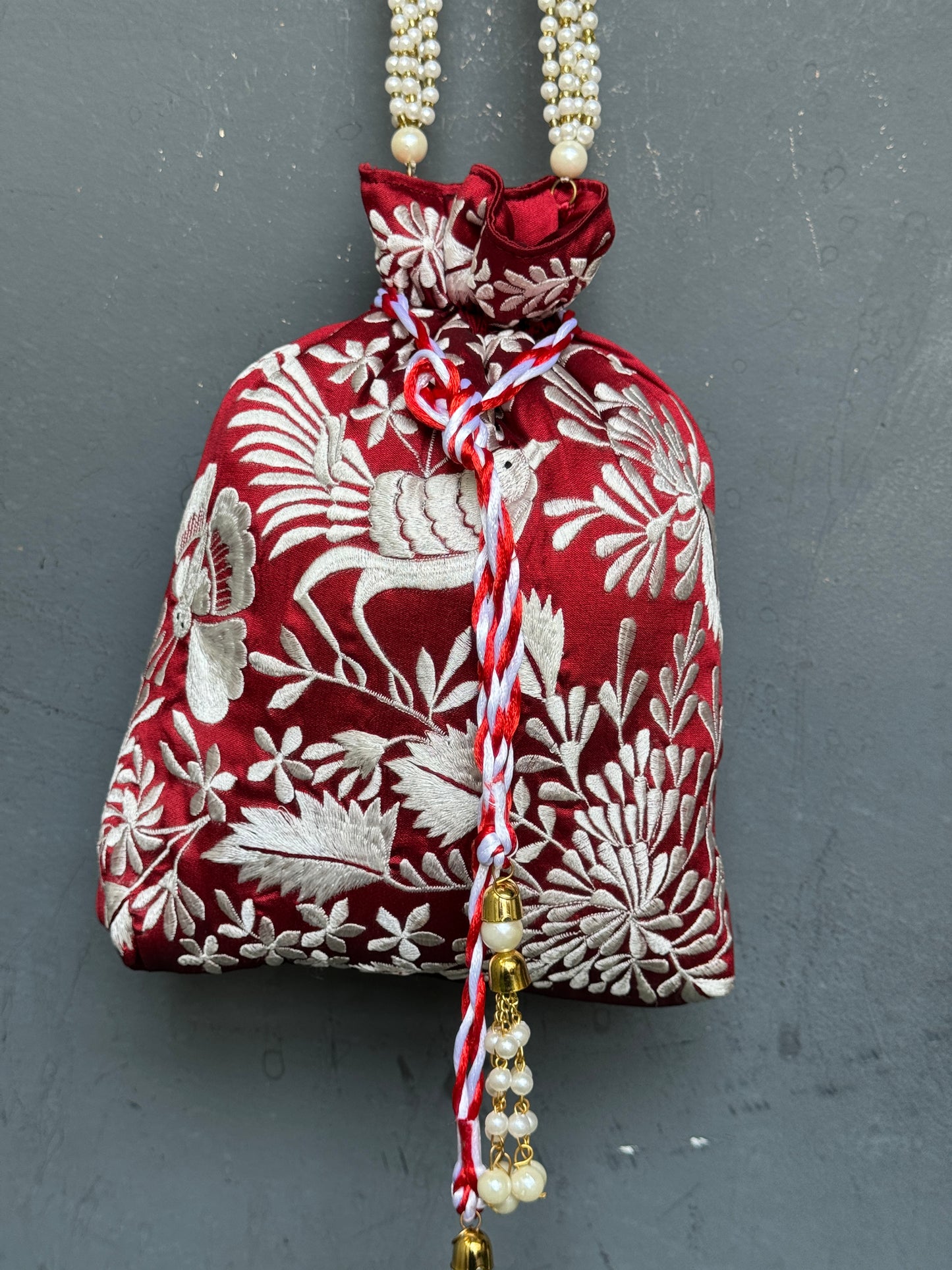 Parsi work party wear potlis with machine embroidery on art silk and pearl chain handle