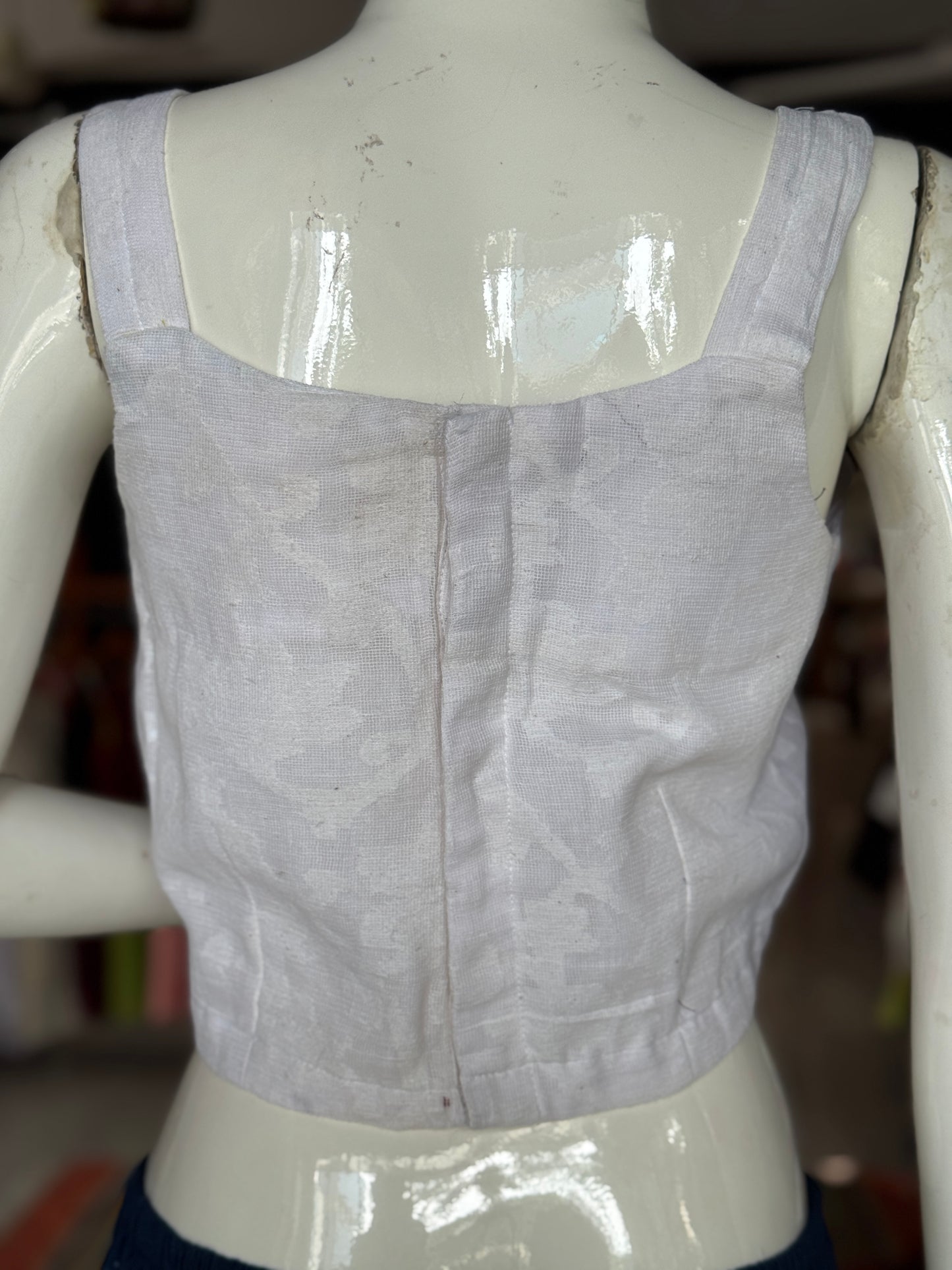 Off White cut work cotton sleeveless blouse