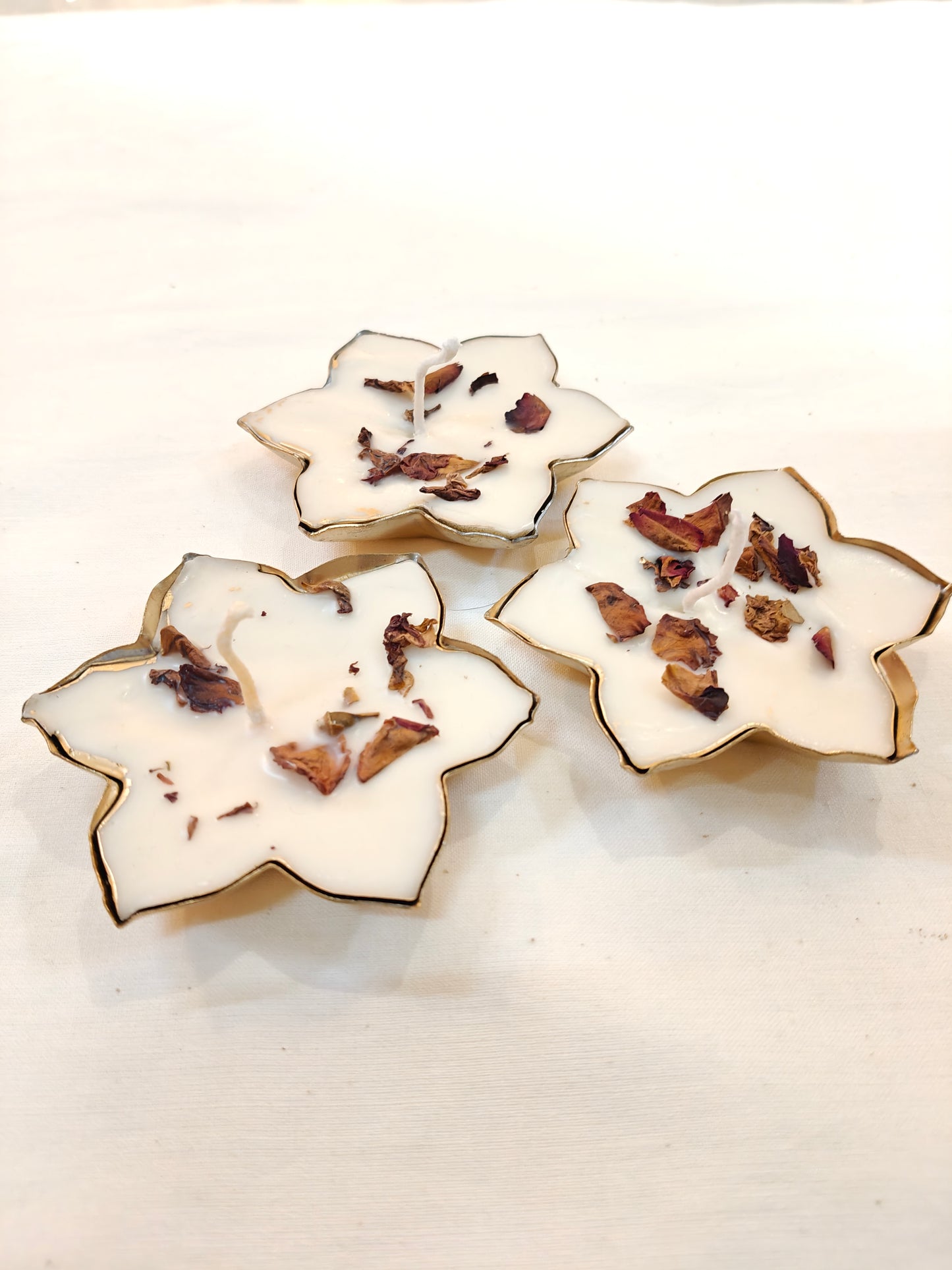 Flower shaped decorative metal base with dry flowers decorated wax candle