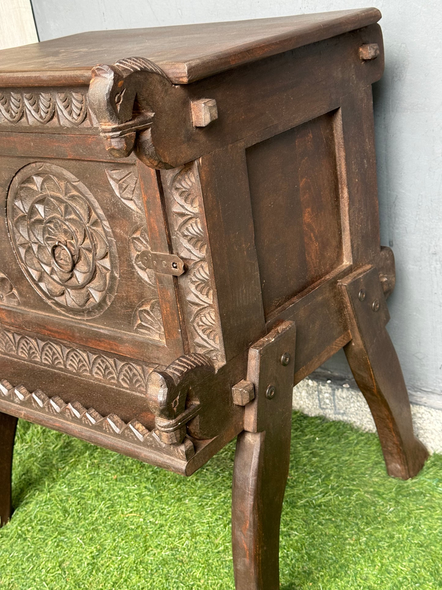Wooden side table with carved flower door and horses on the corners