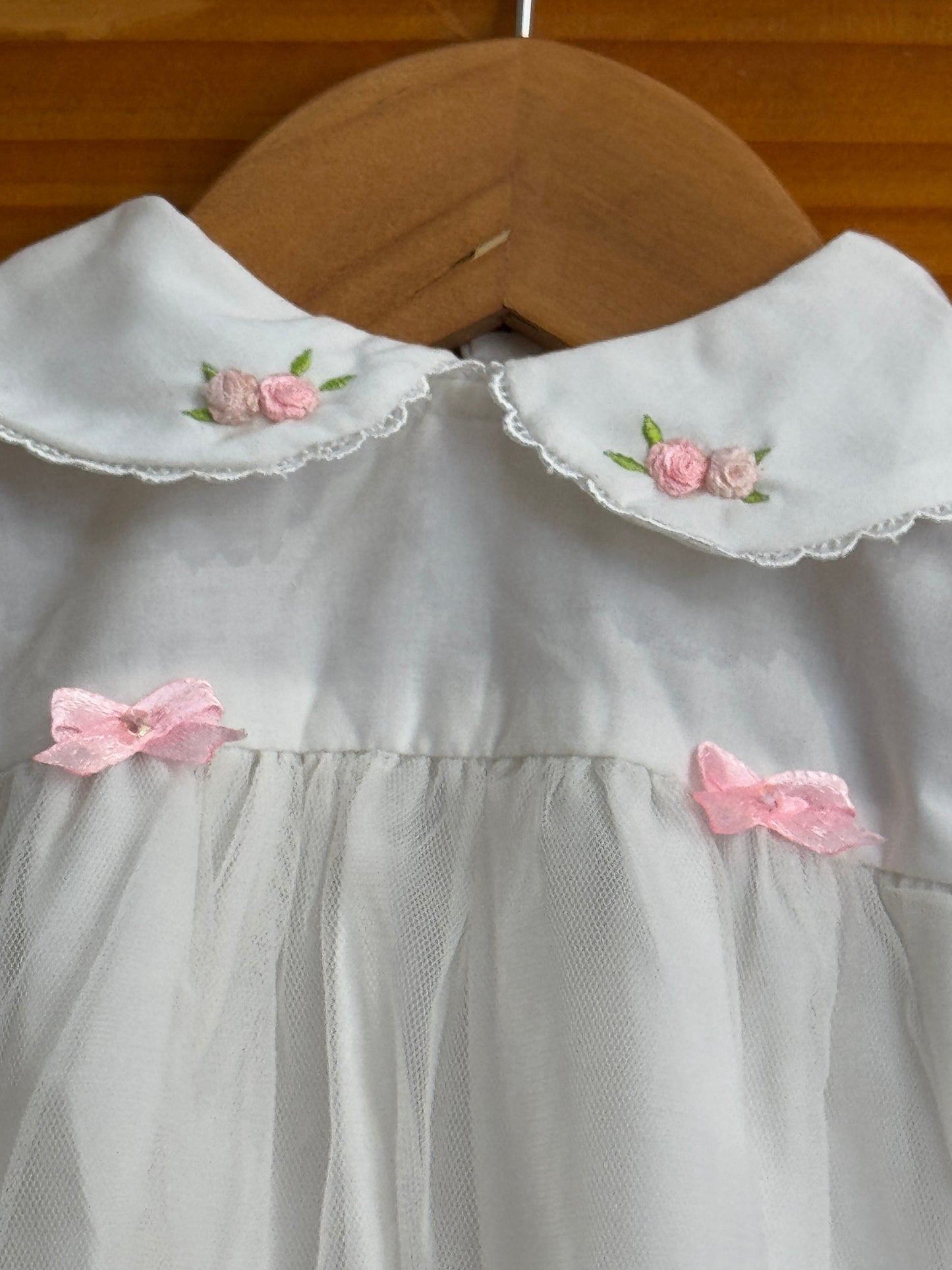 White peter pen collared cotton baby frock with cute embroidery and net layer on top