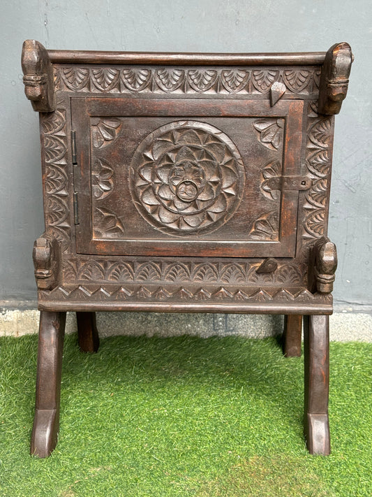 Wooden side table with carved flower door and horses on the corners