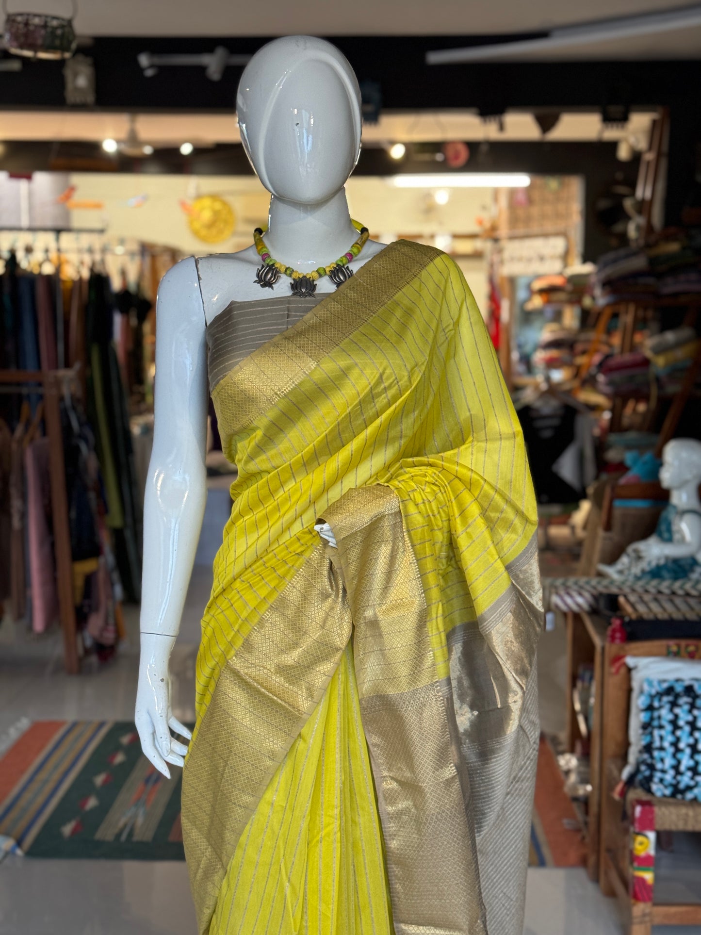 Yellow silk cotton Maheshwari handloom saree with zari pallu and vertical stripes all over