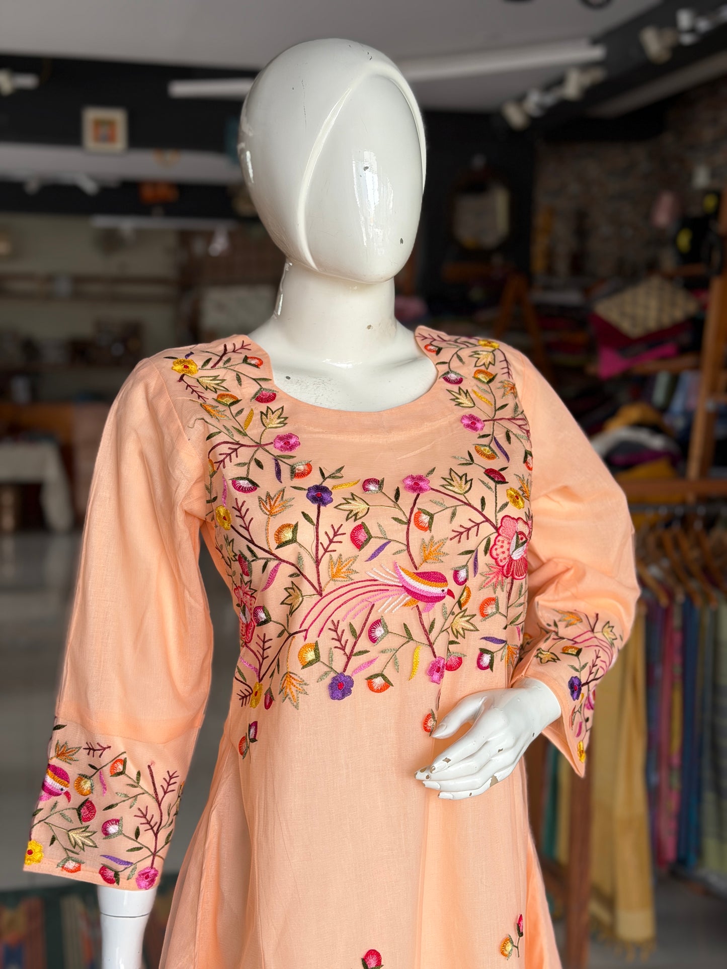 Peach hand embroidered birds and flowers design a-line net kurti with cotton lining