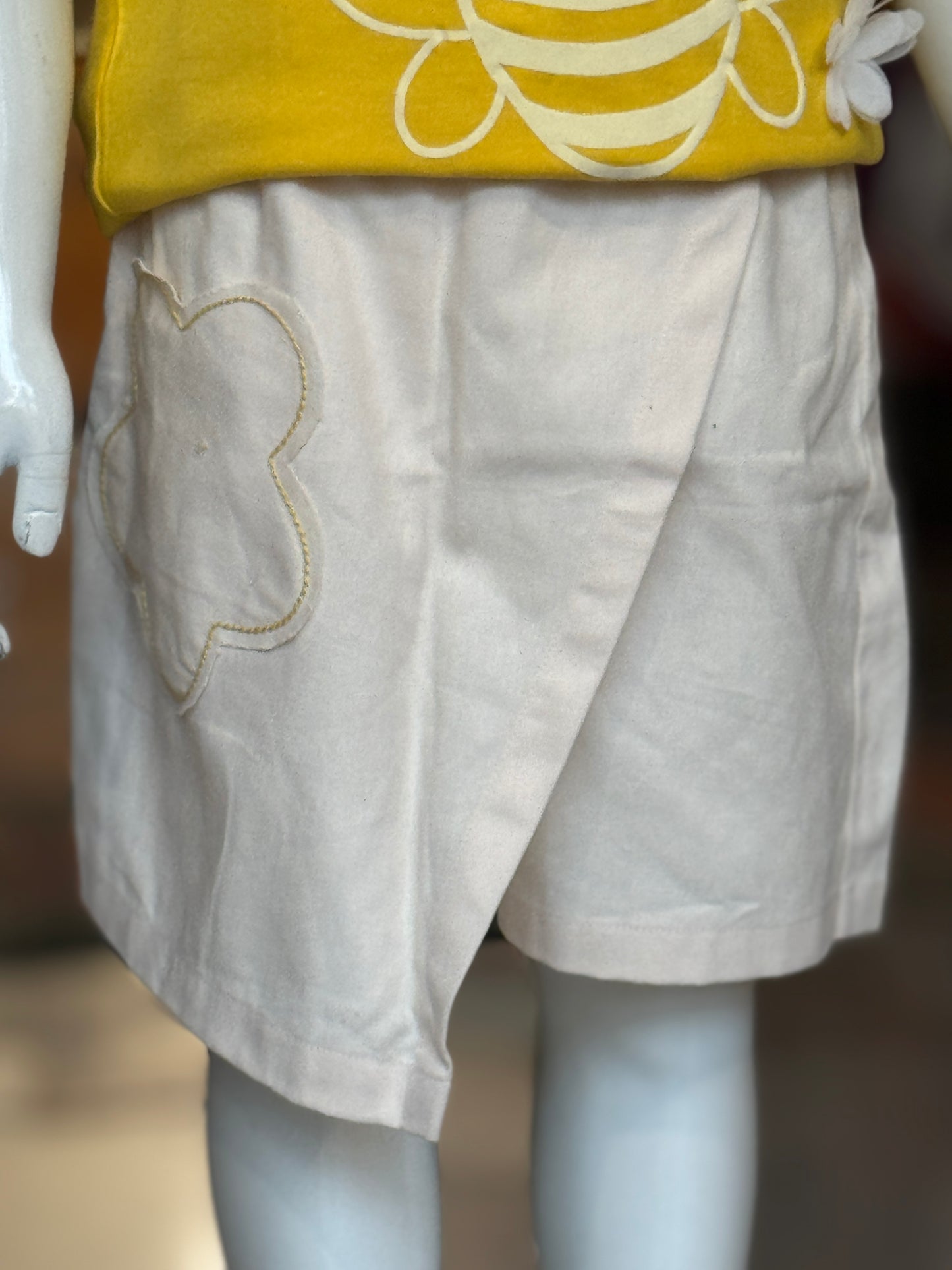 Cream skirt style shorts with flower patch pocket