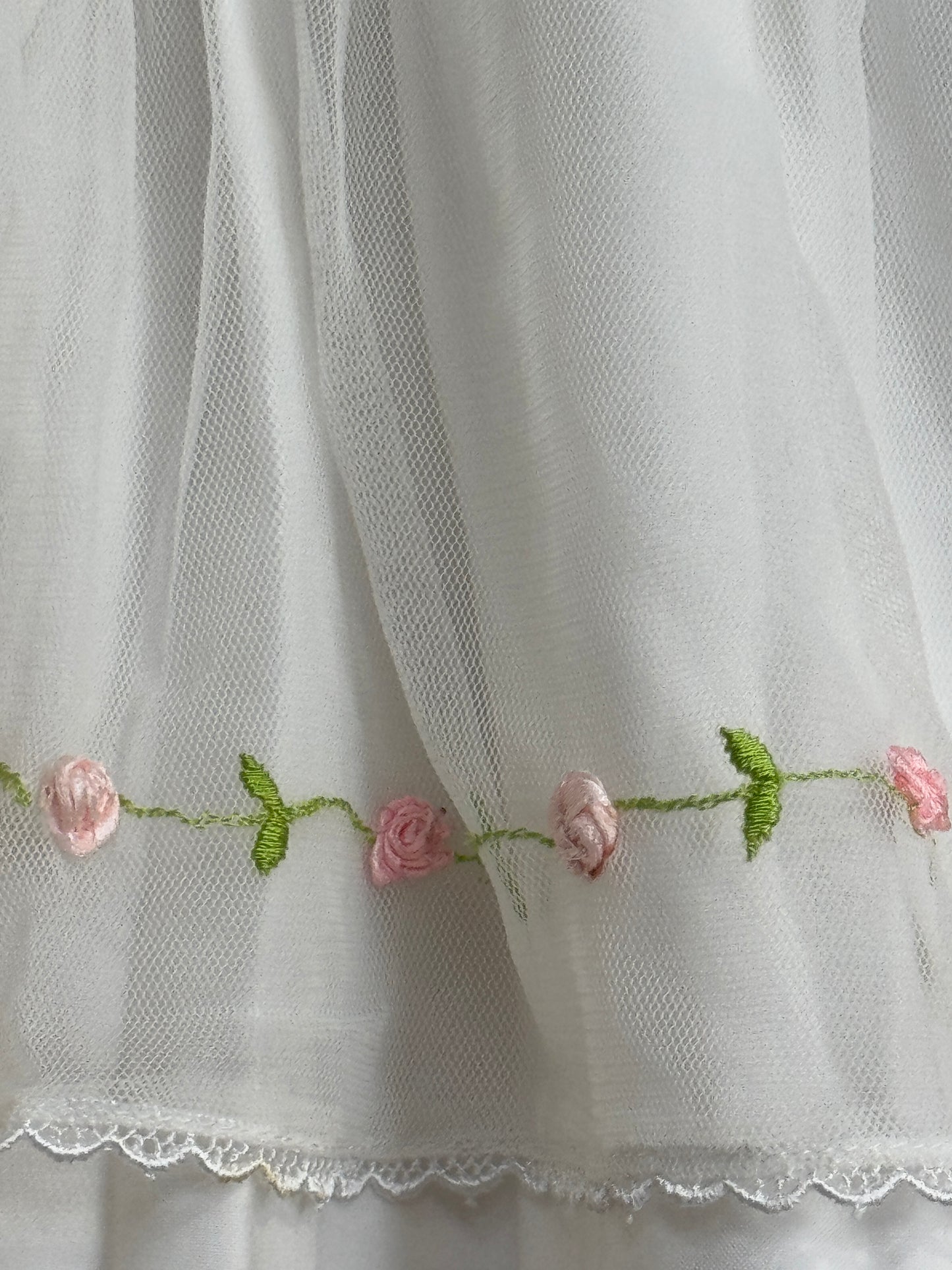 White peter pen collared cotton baby frock with cute embroidery and net layer on top