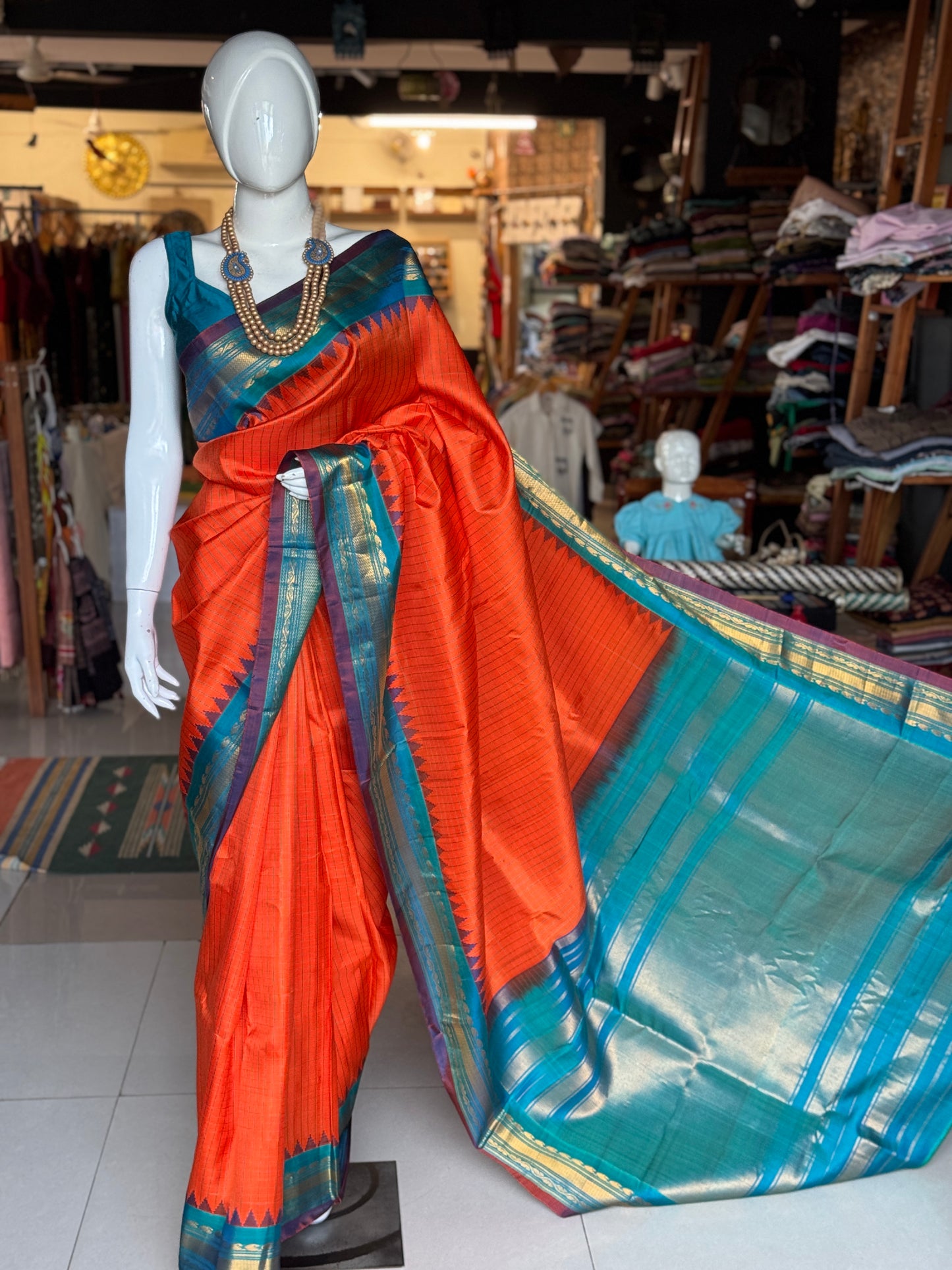 Gold spot orange and blue checks pure silk handwoven Gadwal saree with kuttu temple border