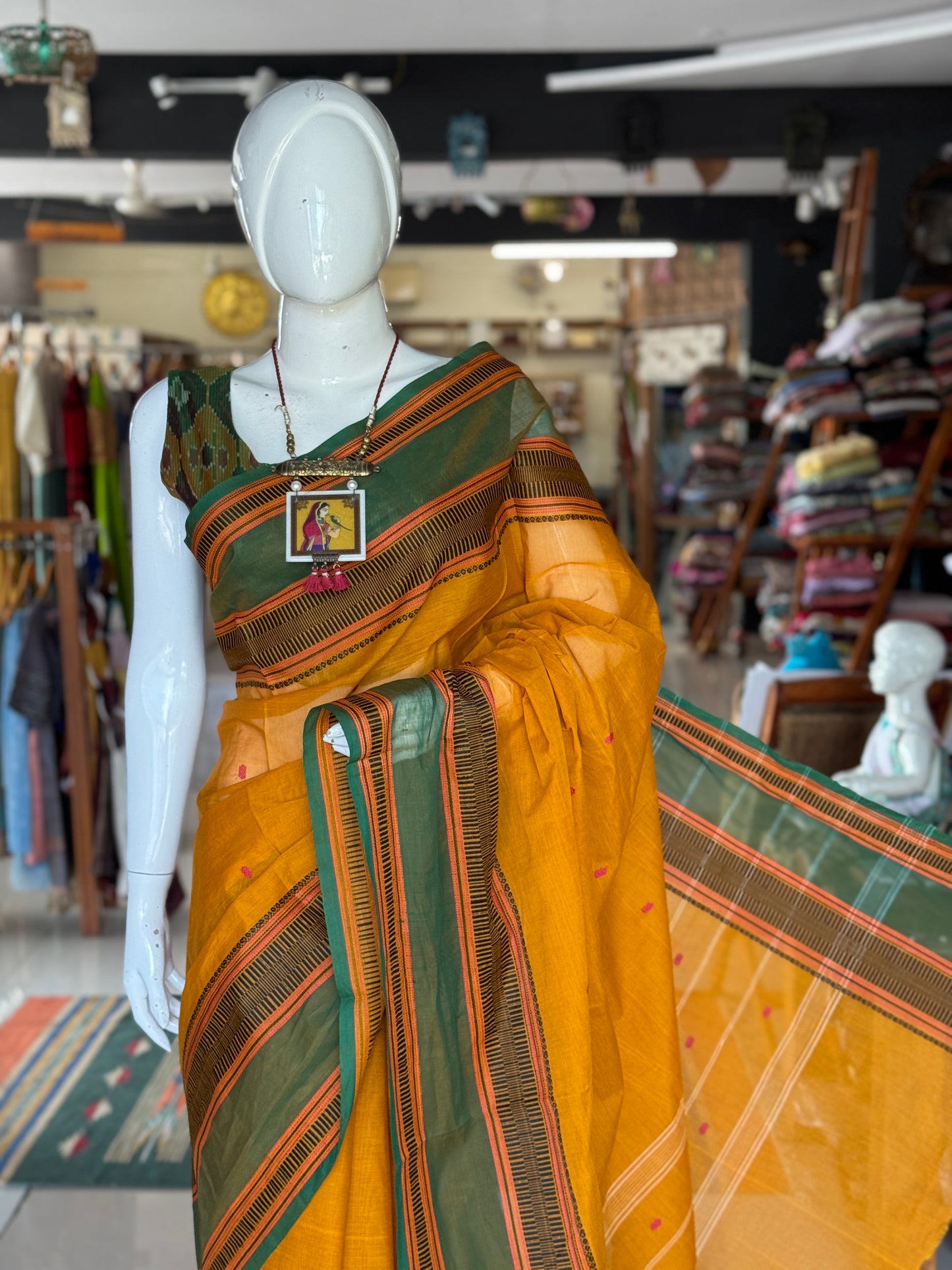 Mustard yellow and green Chettinad cotton handloom saree with butis all over and wide borders