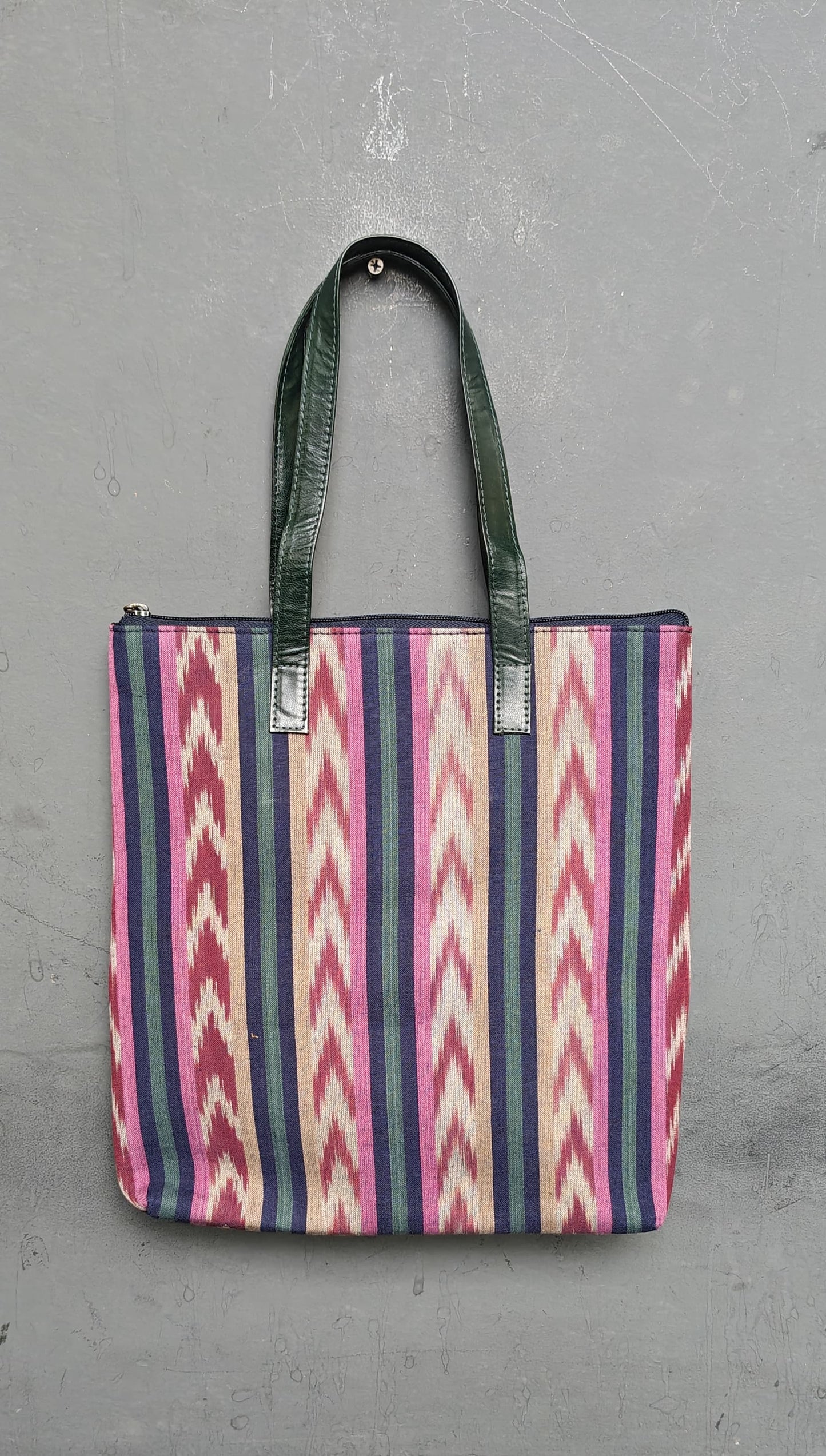 Hand crafted fabric tote bag with leatherflap closure front pocket and leather handles