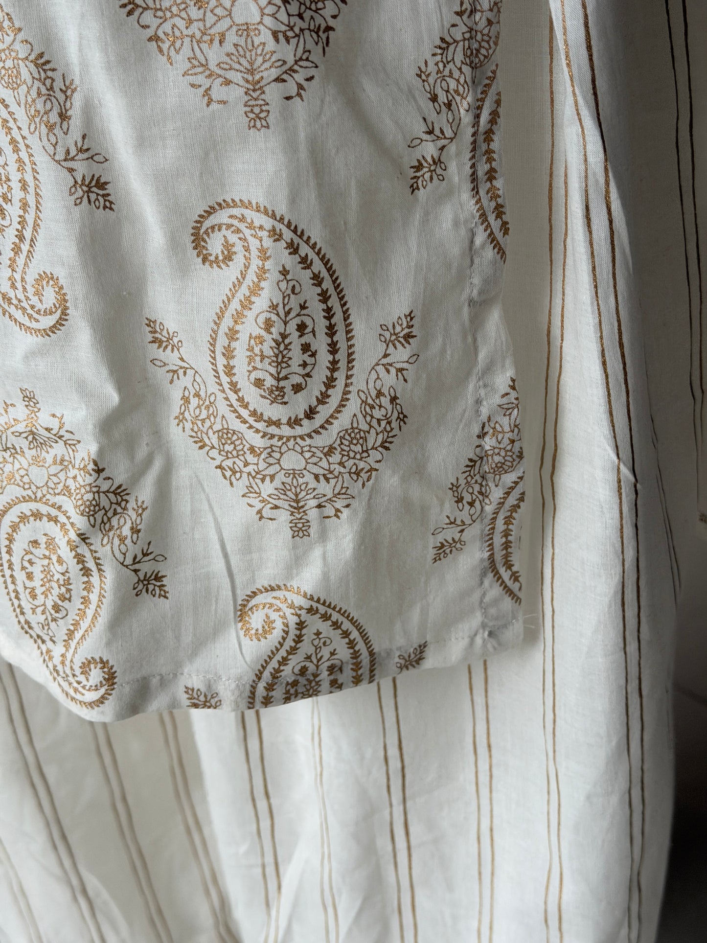 Off white paisley print cotton kurti paired with a matching stripes print barrel pants - 2 piece set