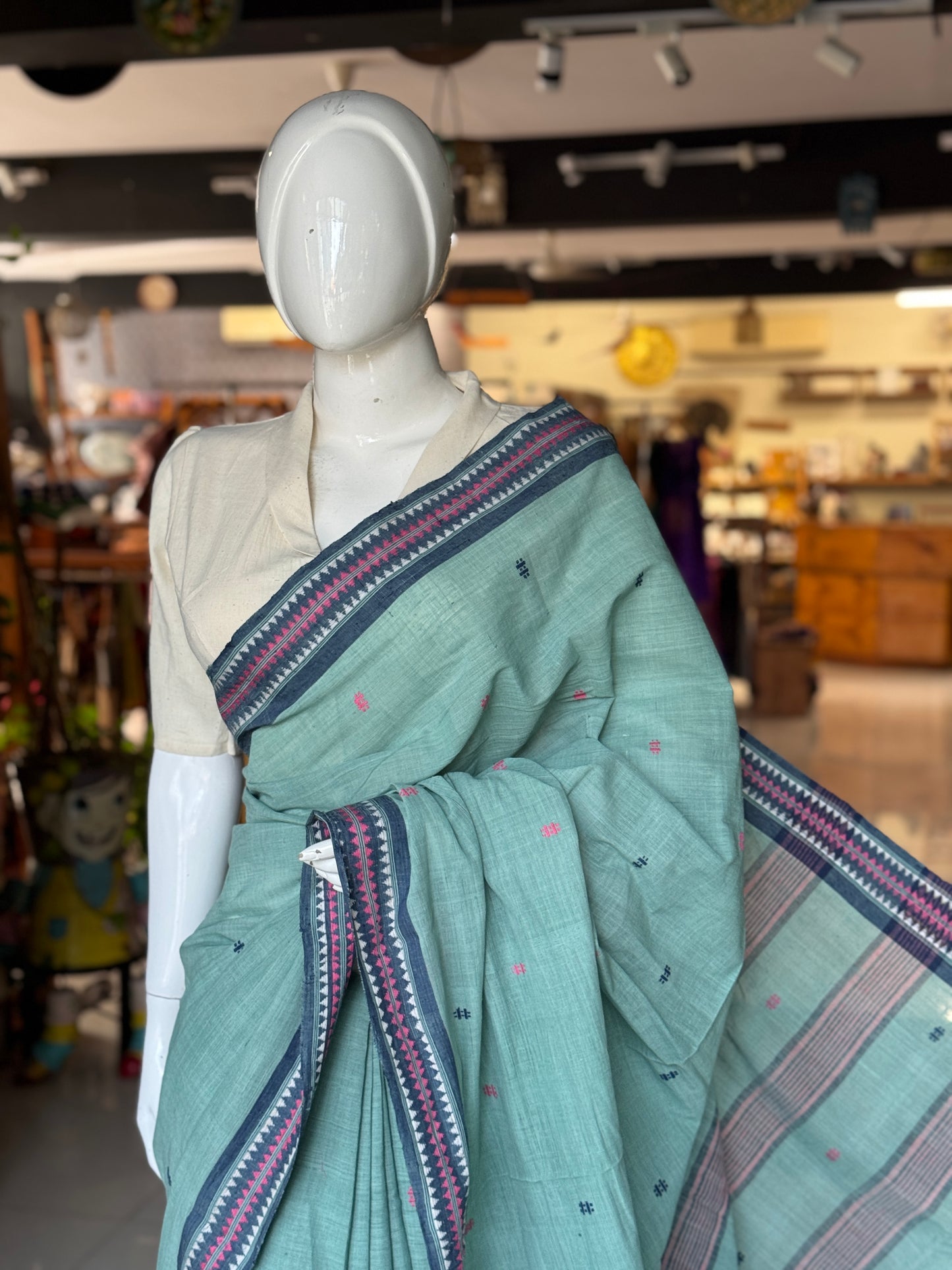 Pastel bluish green coarse textured handloom cotton saree with small butis and thread border