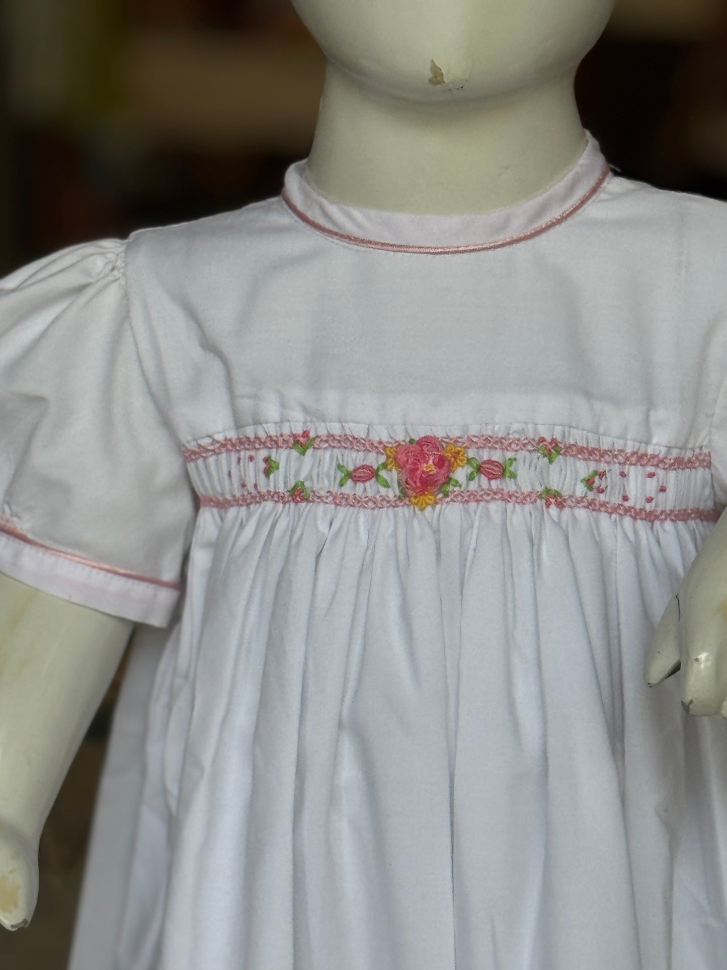 White hand embroidered smocking cotton frock for girls with piping at neck line