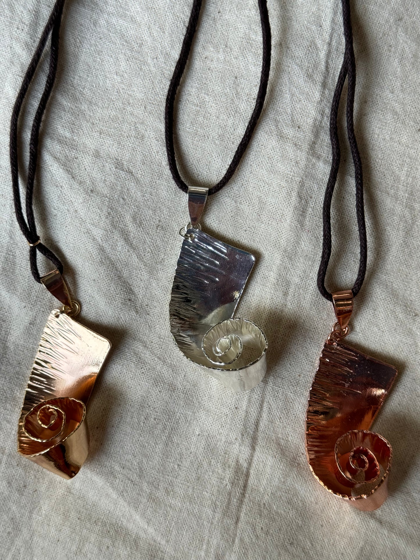 Vakratunda, twisted elephant trunk handcrafted copper pendant with brown thread