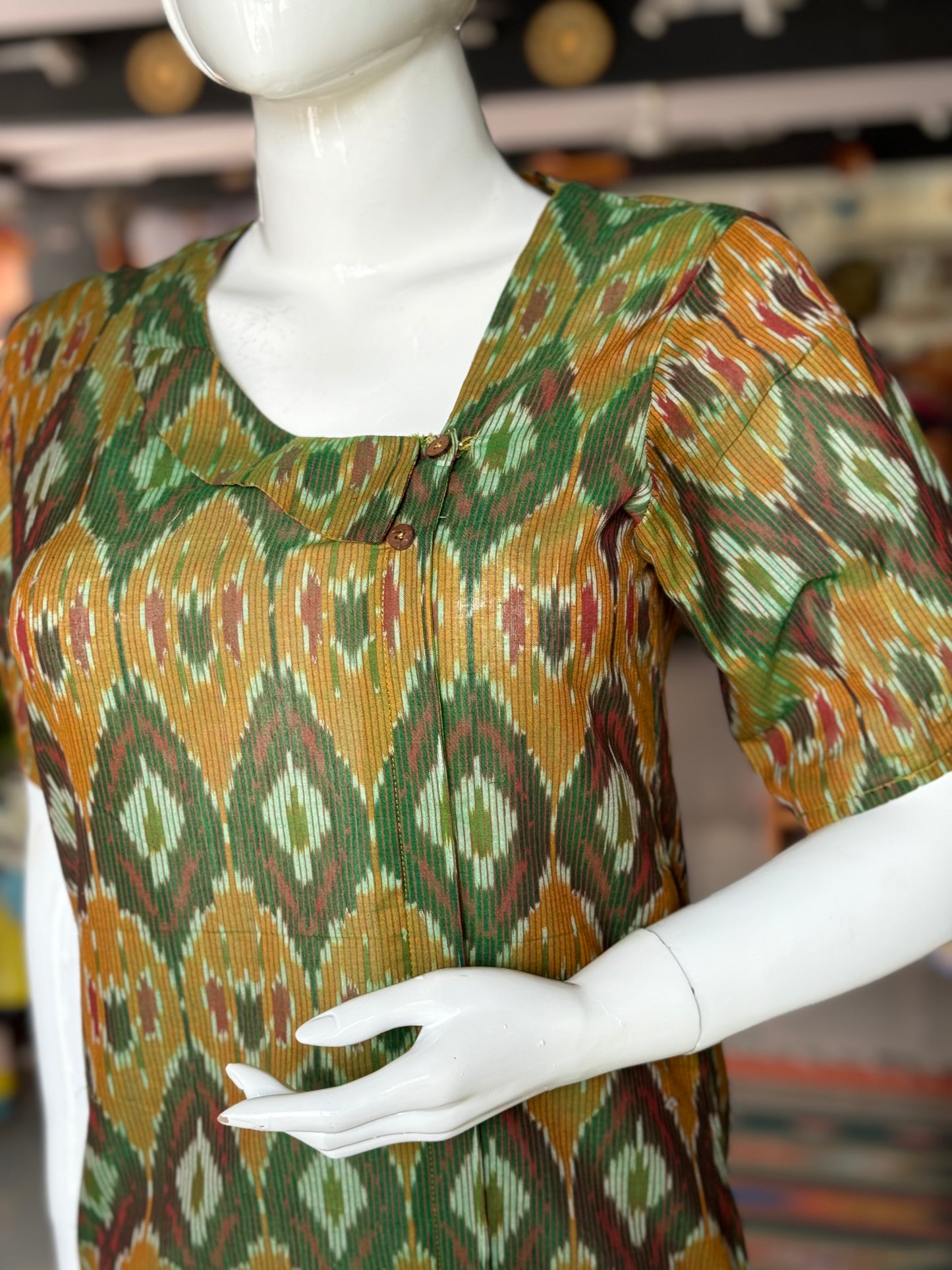 Dark green handloom ikat mercerised cotton top for women with asymmetric neckline