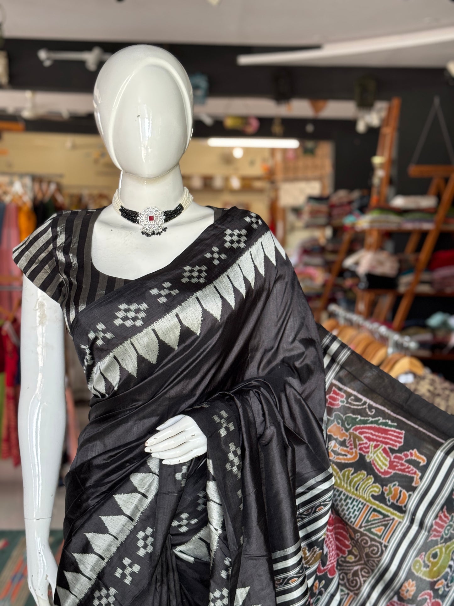 Ikat splendor - black and silver pure silk handloom saree with colorful Ikat pallu and temple border