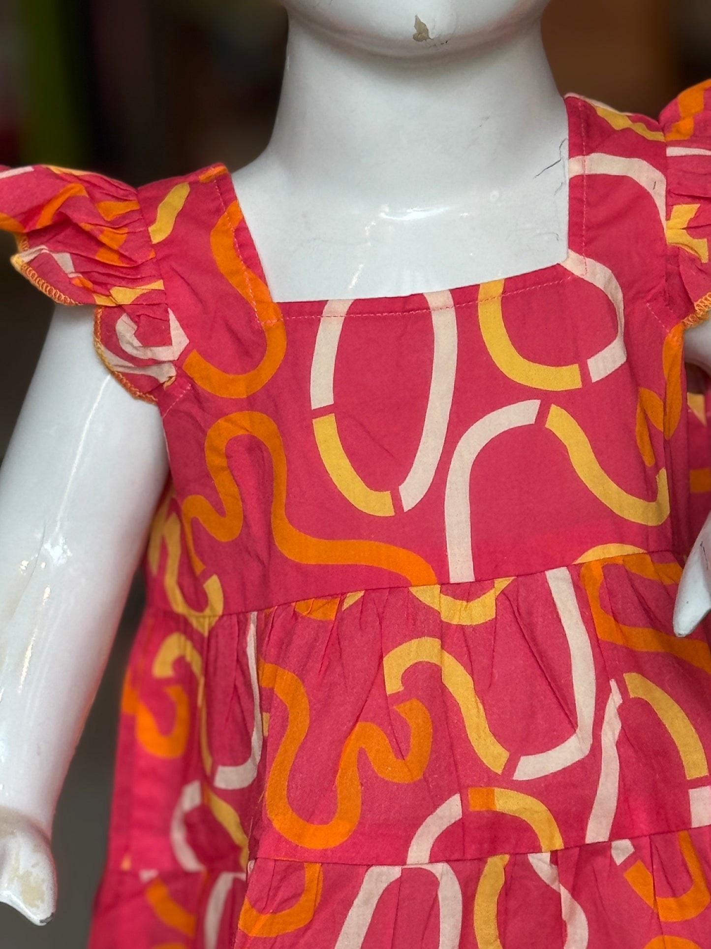Warm salmon peach printed frock for girls
