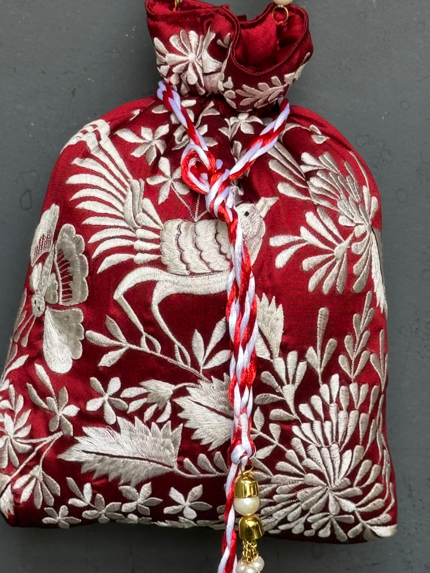 Parsi work party wear potlis with machine embroidery on art silk and pearl chain handle