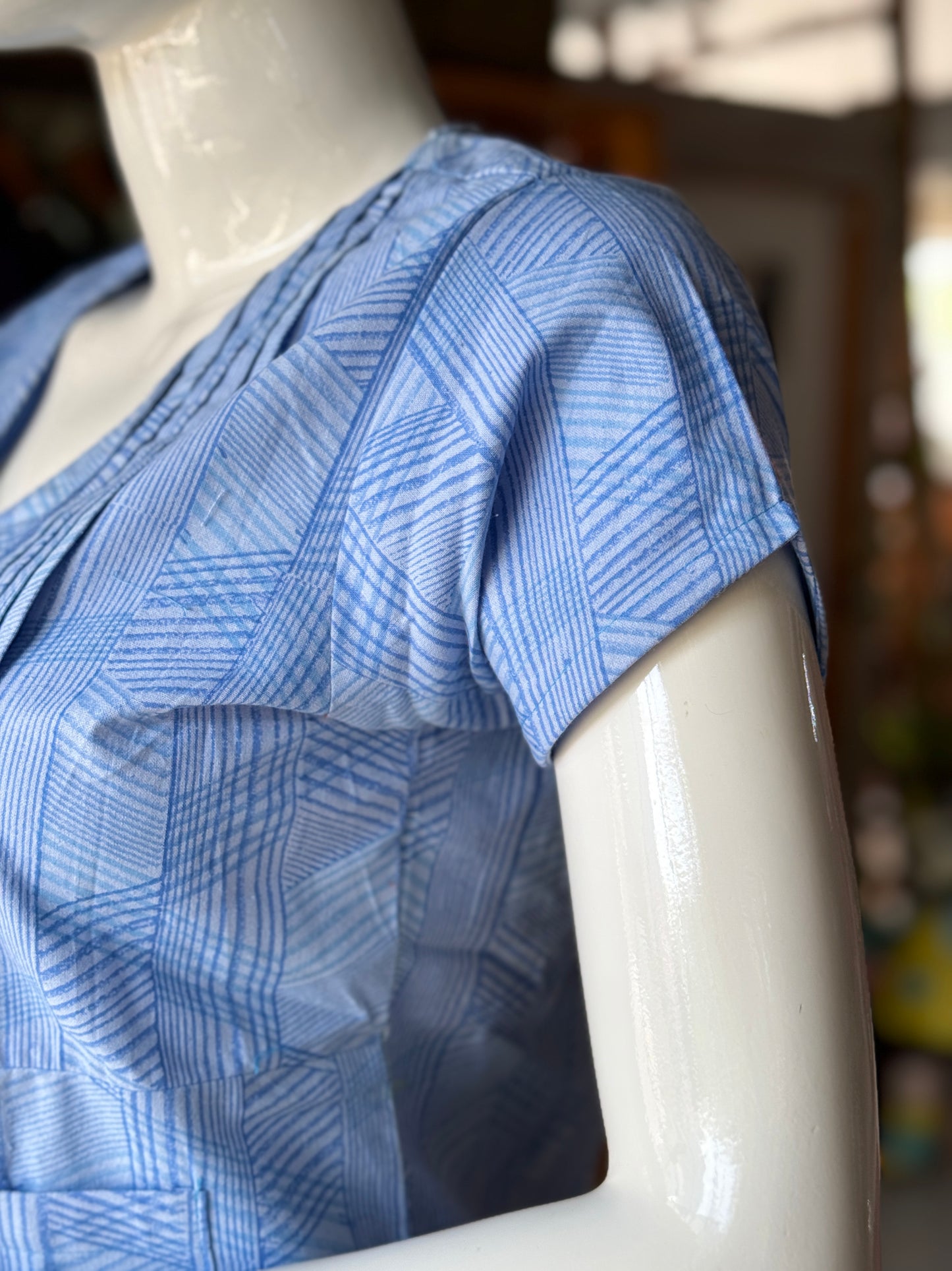 Blue geometric hand block printed cotton top with asymmetric pintucks and one side pocket