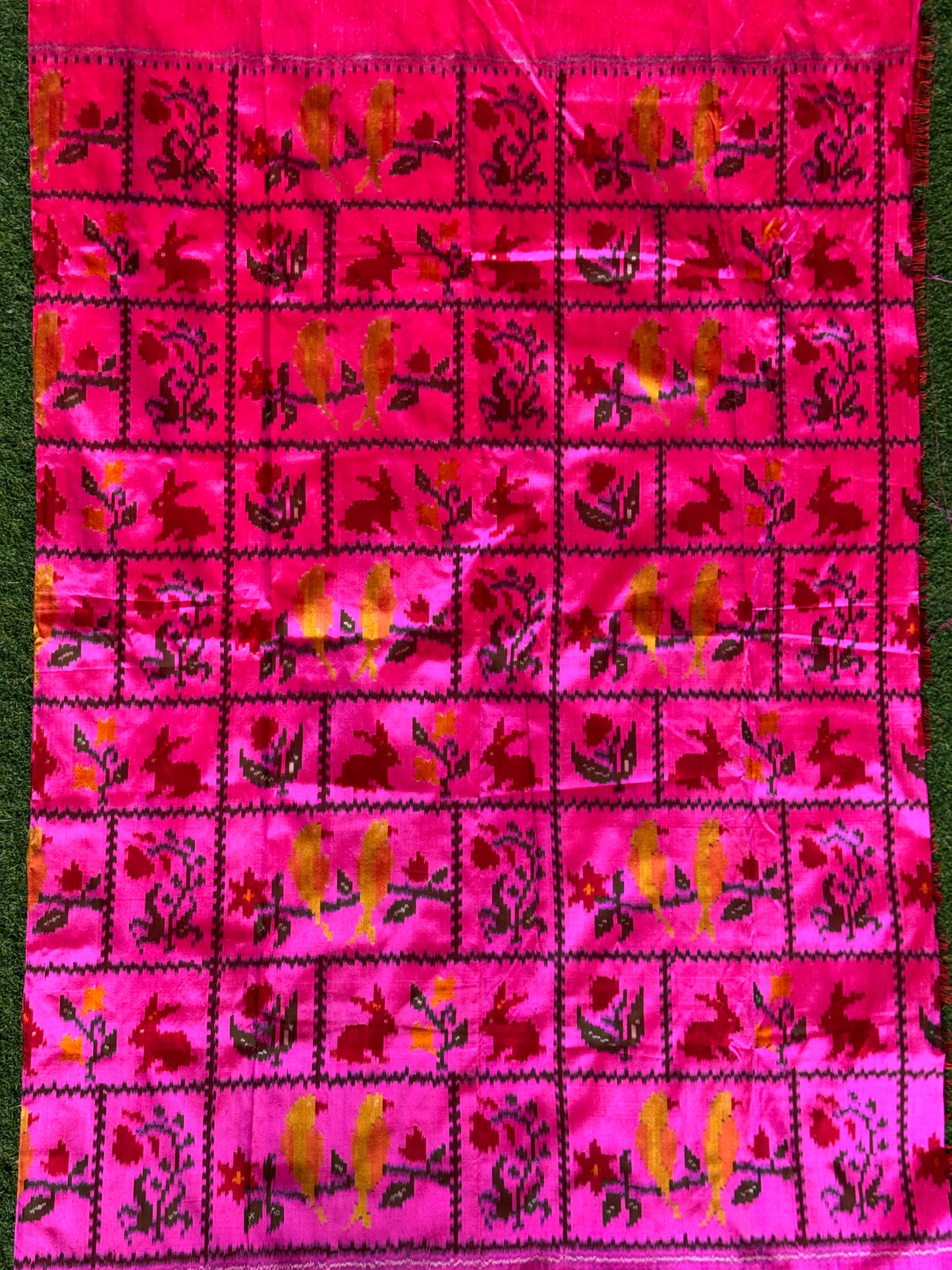 Hot pink pattu ikat silk handwoven fabric with rabbits, birds n flowers motif