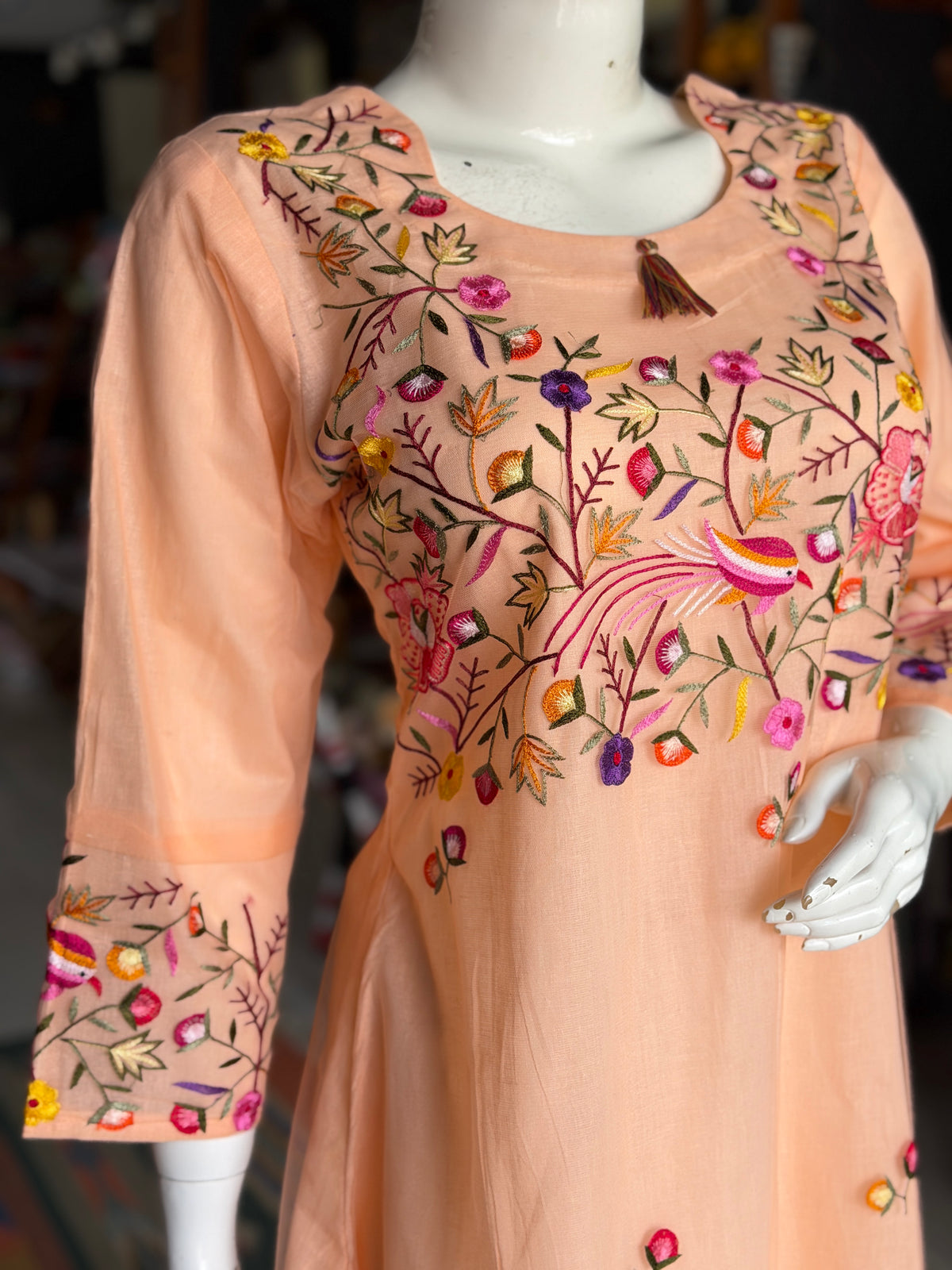 Peach hand embroidered birds and flowers design a-line net kurti with cotton lining