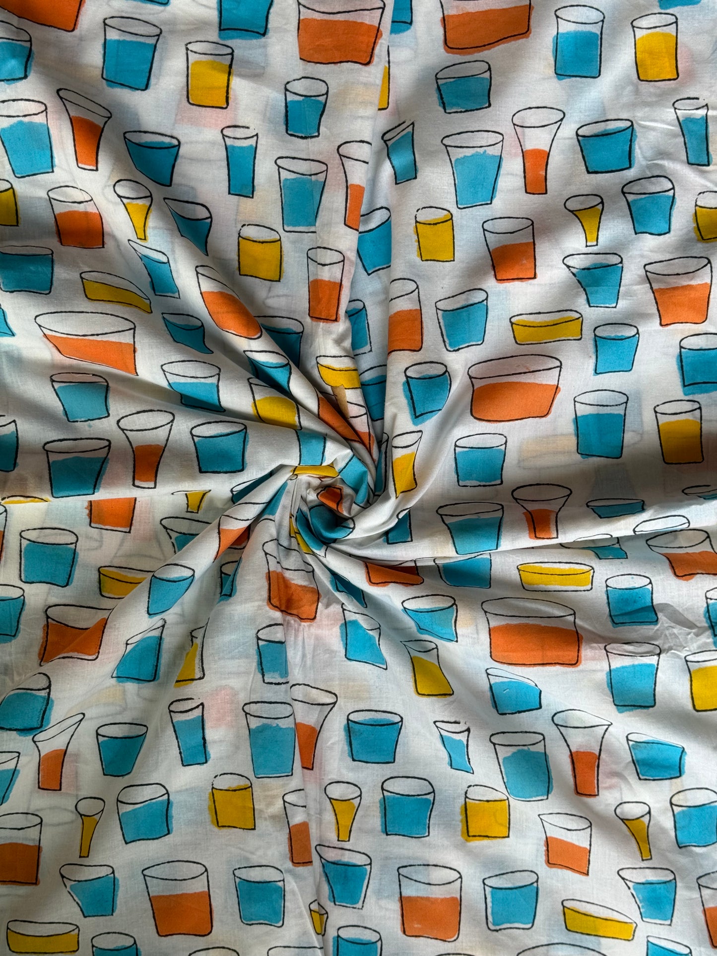 Colourful tumblers hand block printed on white soft cotton fabric