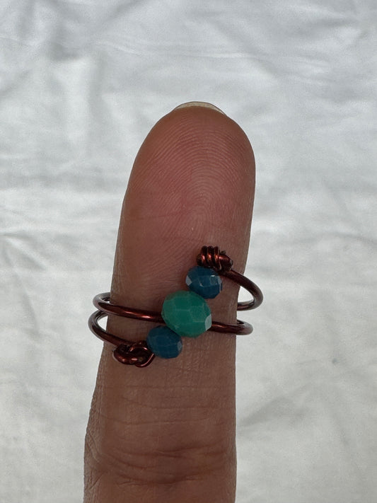 Copper twisted wire finger ring with blue green beads