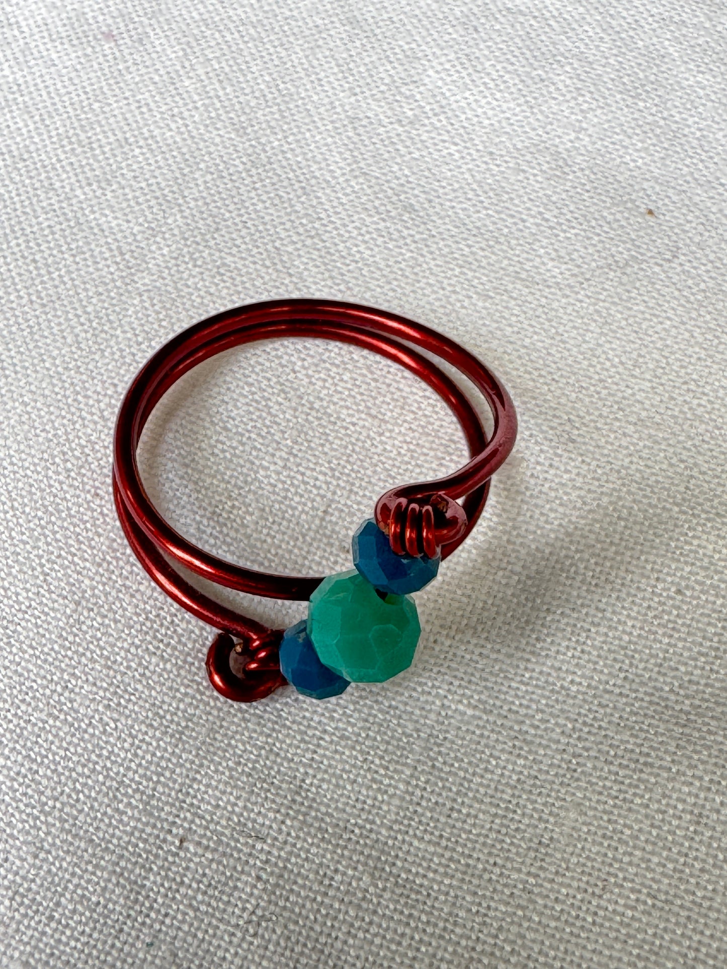 Copper twisted wire finger ring with blue green beads