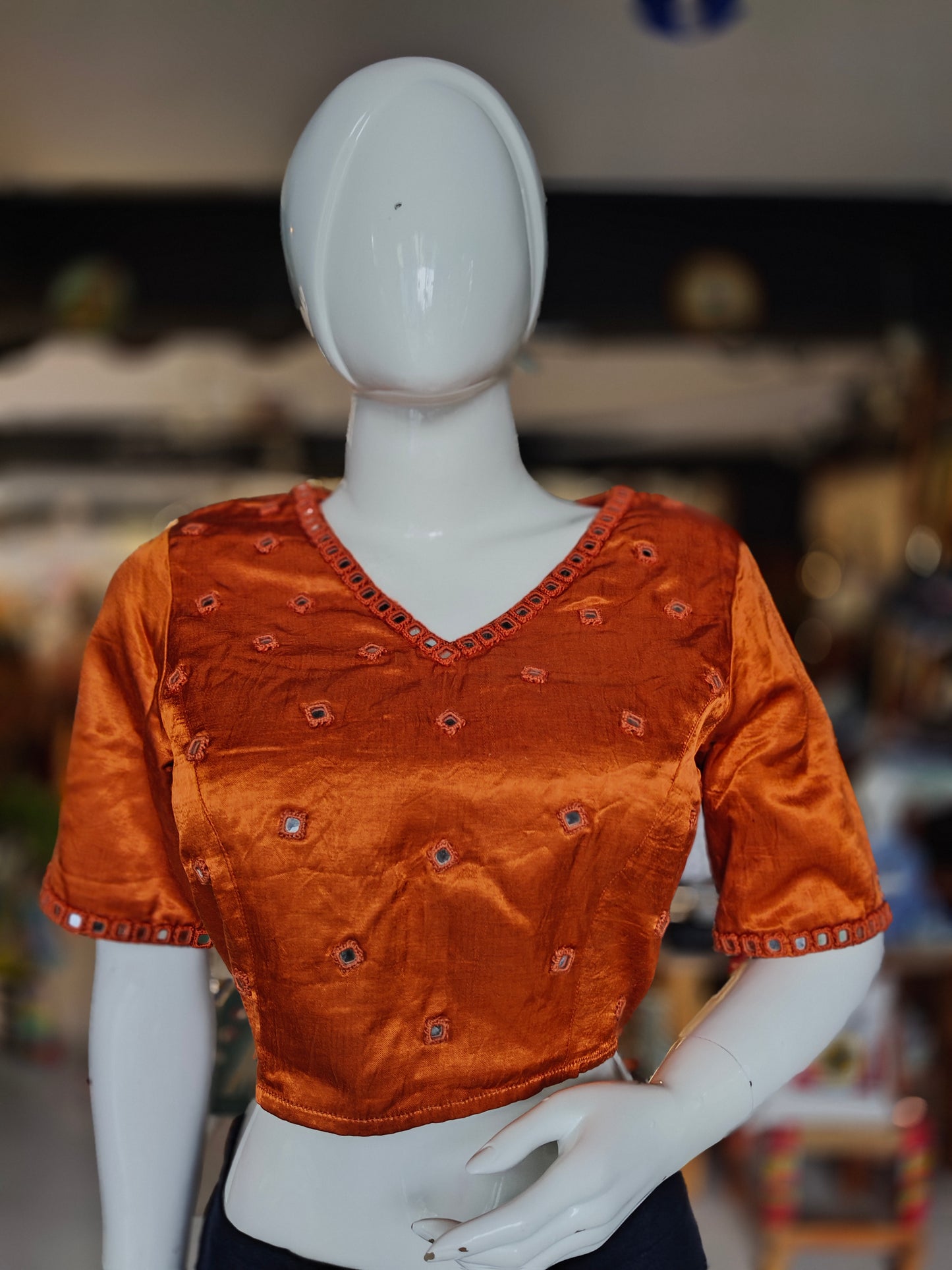 Burnt orange mashru blouse with square mirrors embroidered on front and sleeves
