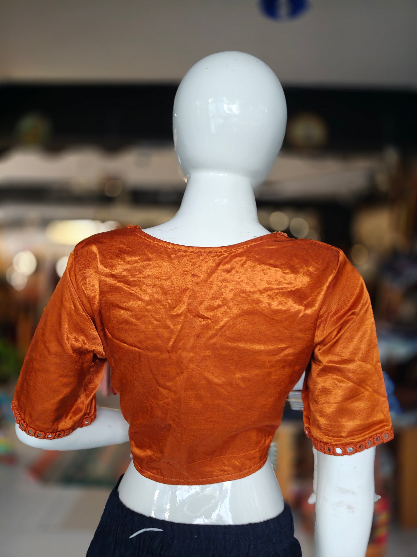 Burnt orange mashru blouse with square mirrors embroidered on front and sleeves