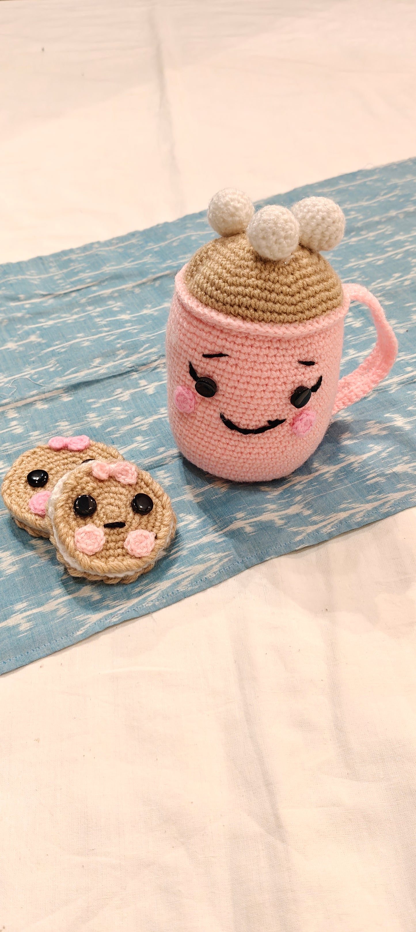 Cute Pink hot chocolate cup with marshmallows topping and cute faced cookies by the side - handcrafted crochet