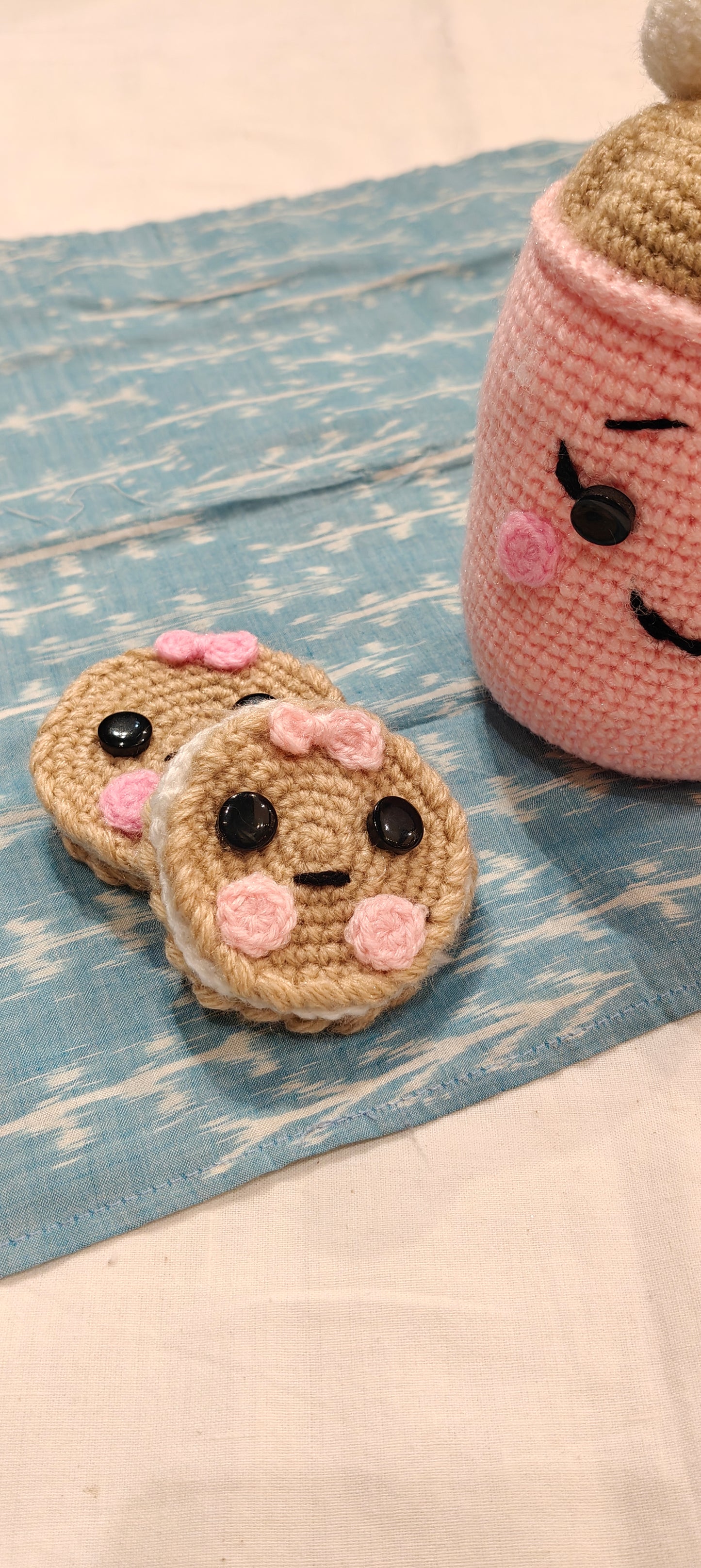Cute Pink hot chocolate cup with marshmallows topping and cute faced cookies by the side - handcrafted crochet
