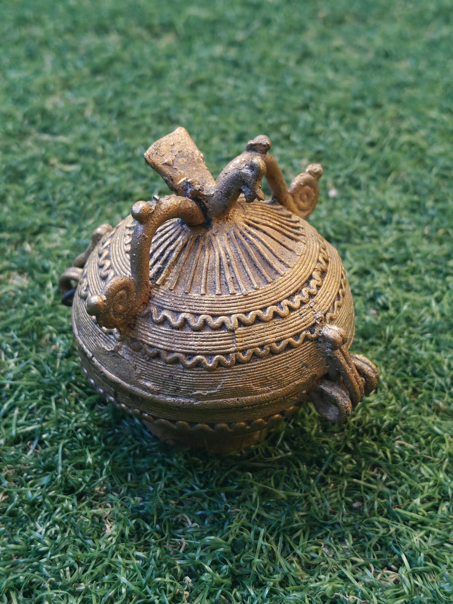 Brass spherical coin box with a bird on top - Dokra Brass handcrafted decor