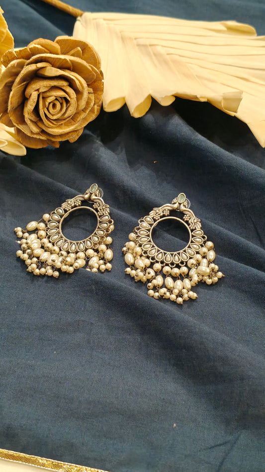 Circular peacock motif earrings with pearl drops