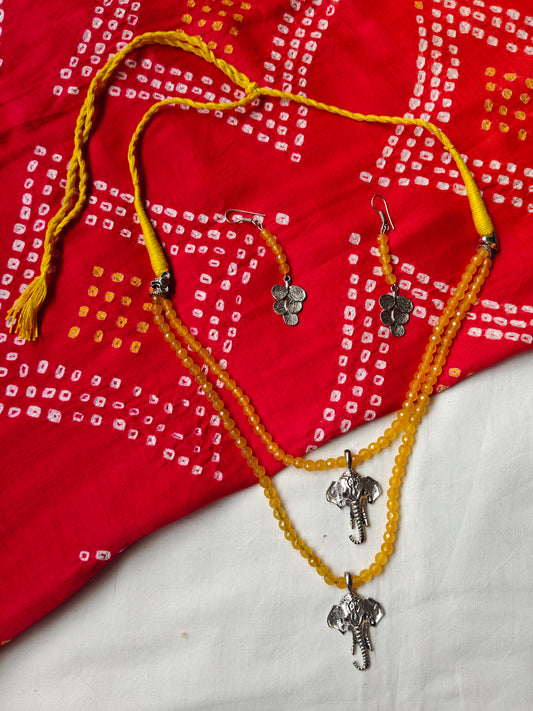 Yellow two layered neckpiece with elephant face pendants and earrings set